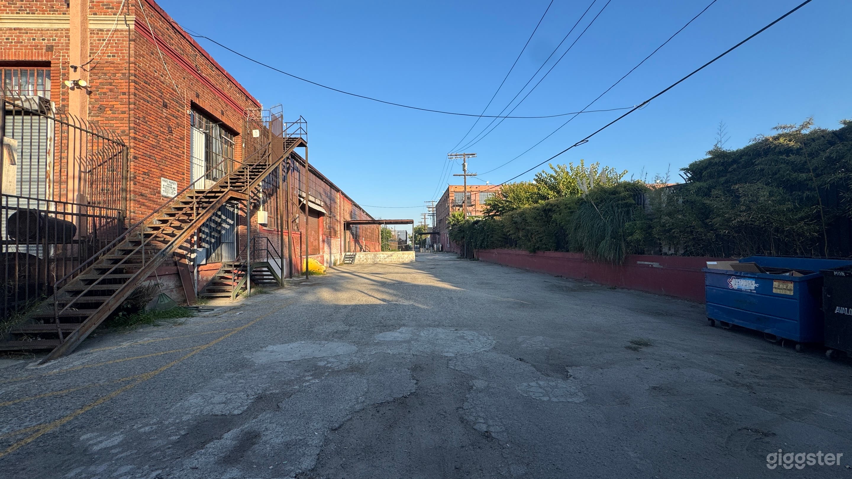 Industrial Red Brick Exterior Gated Parking Lot Photo 3