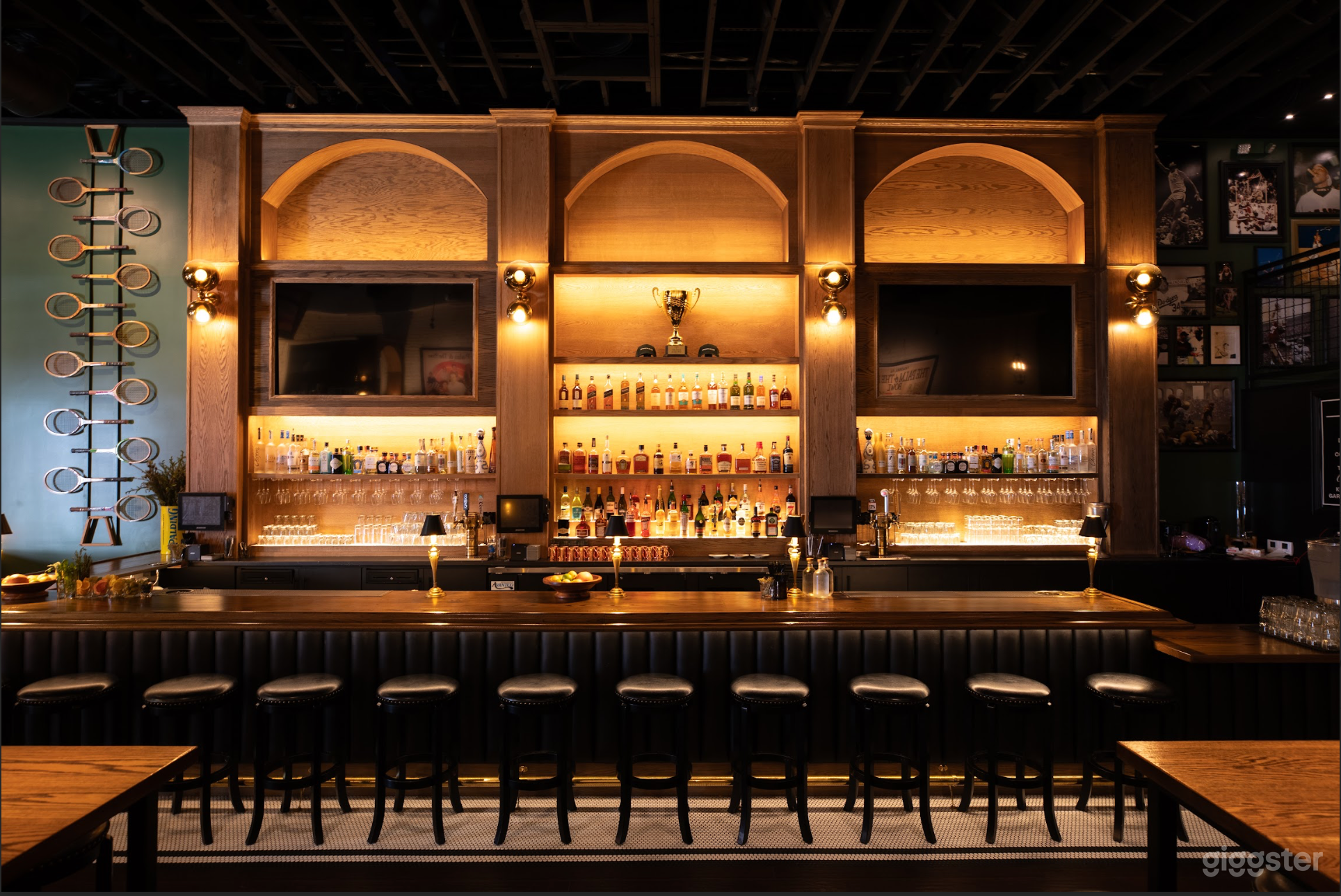 floor to ceiling back bar made with American oak and two 75inch televisions-- color changing lights 