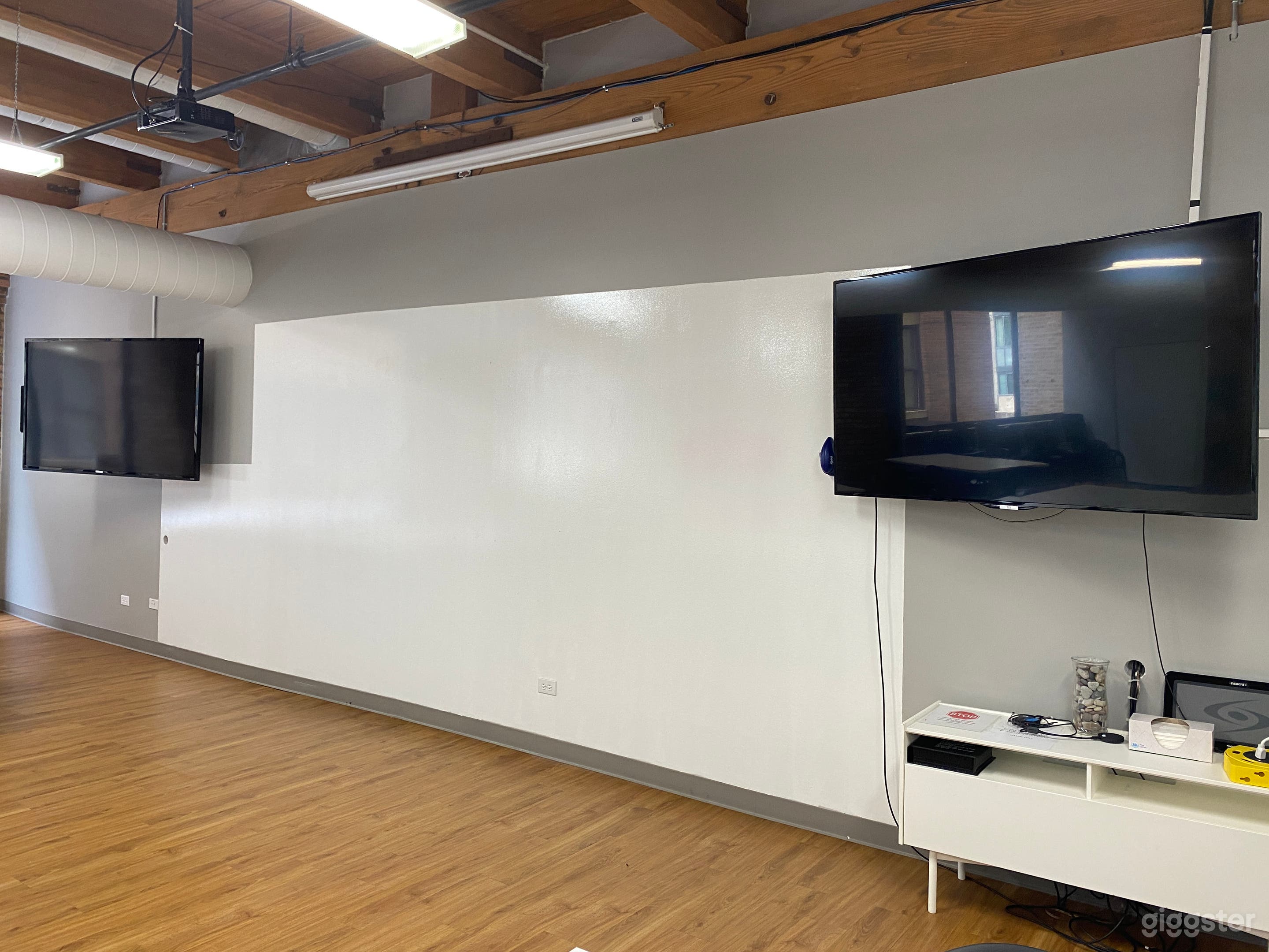 The north wall in the Large Conference Room is a dry-erase wall and has two mounted 70" TVs