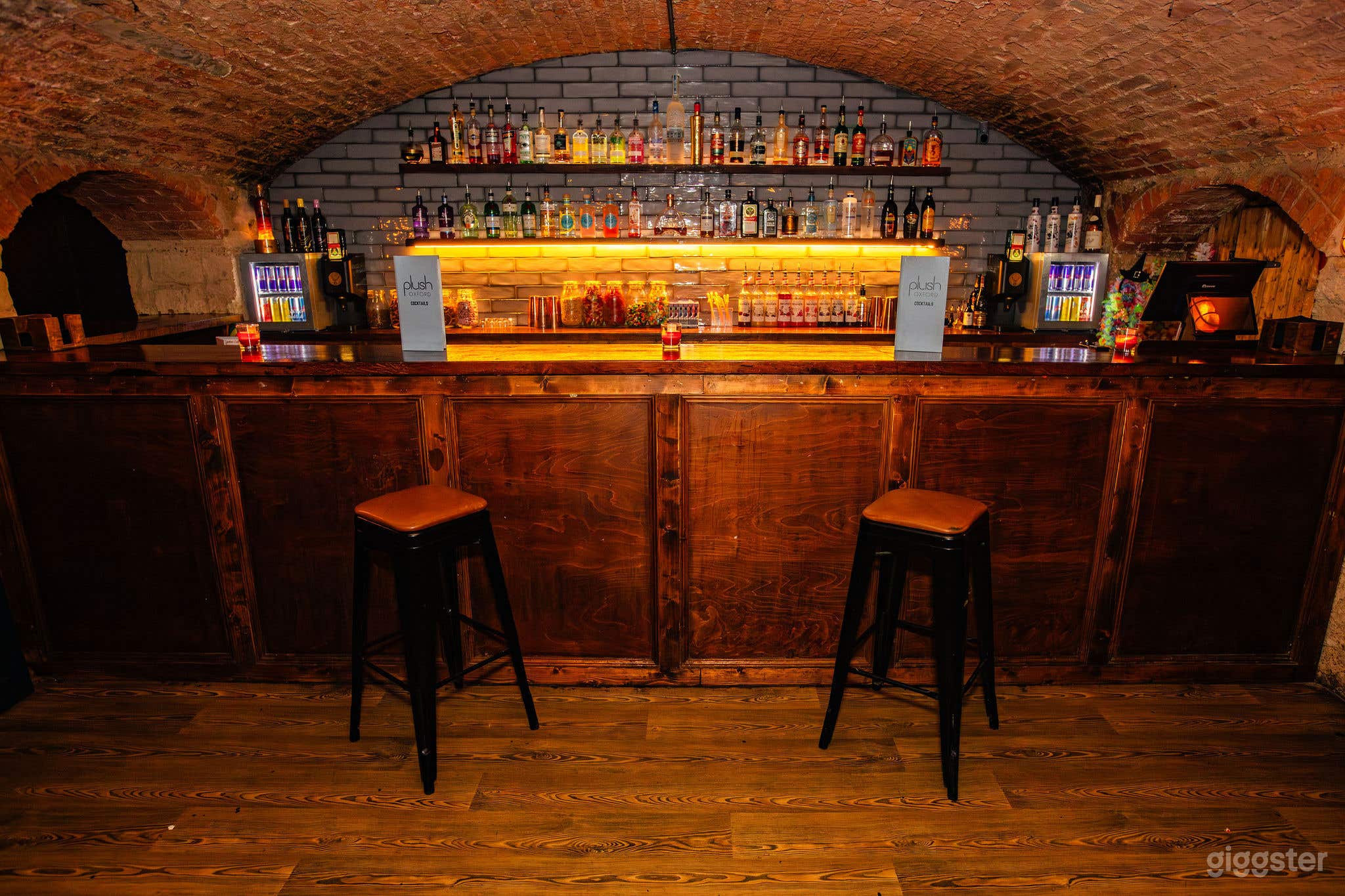 The coctail bar and seating area offers a classic, contemporary feel, with subtle lighting on a solid oak bar.