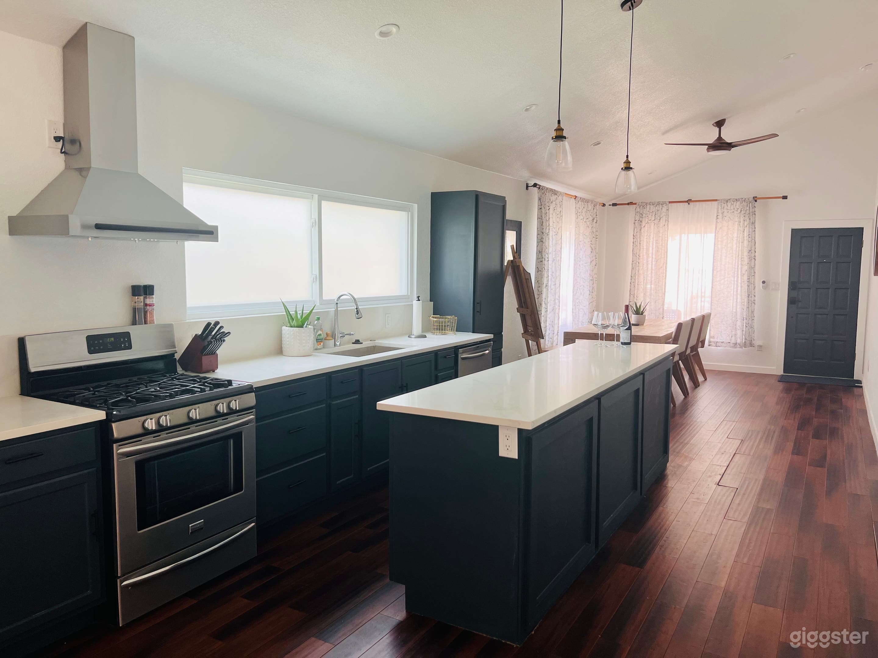 Kitchen &amp; dining area with 8 ft table and island. 