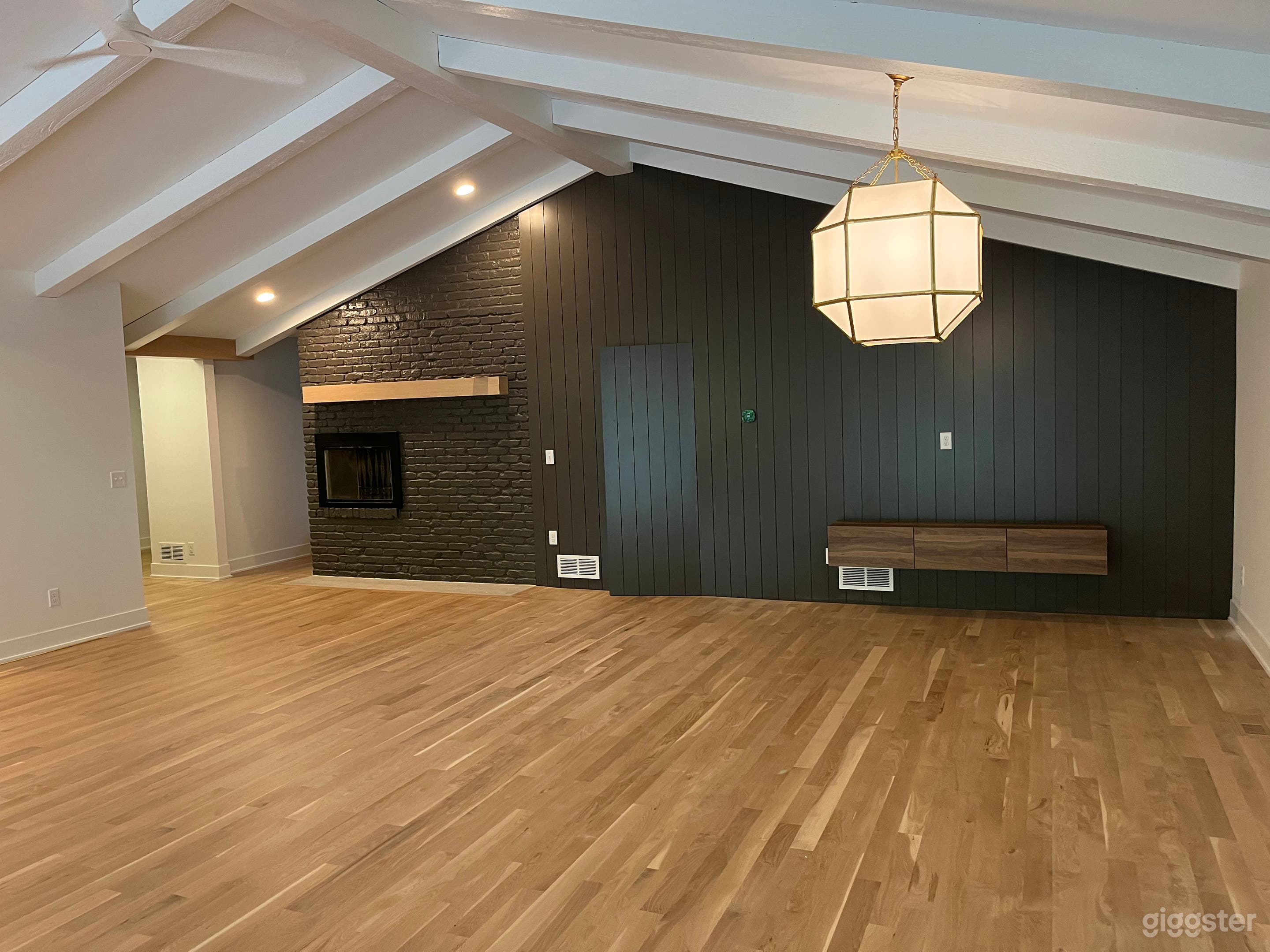 Working wood fireplace, mantle on painted brick; hidden powder room in painted paneled accent wall 