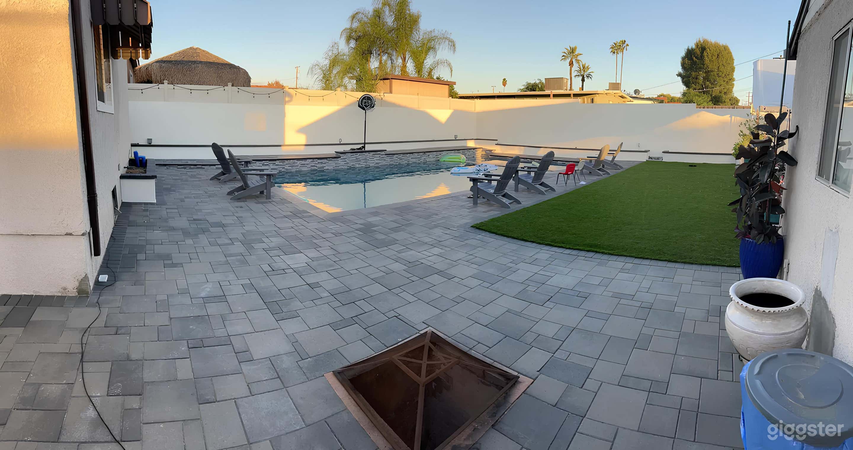 Stylish Pool Lounge with Fire Pit and Covered Seat Photo 2