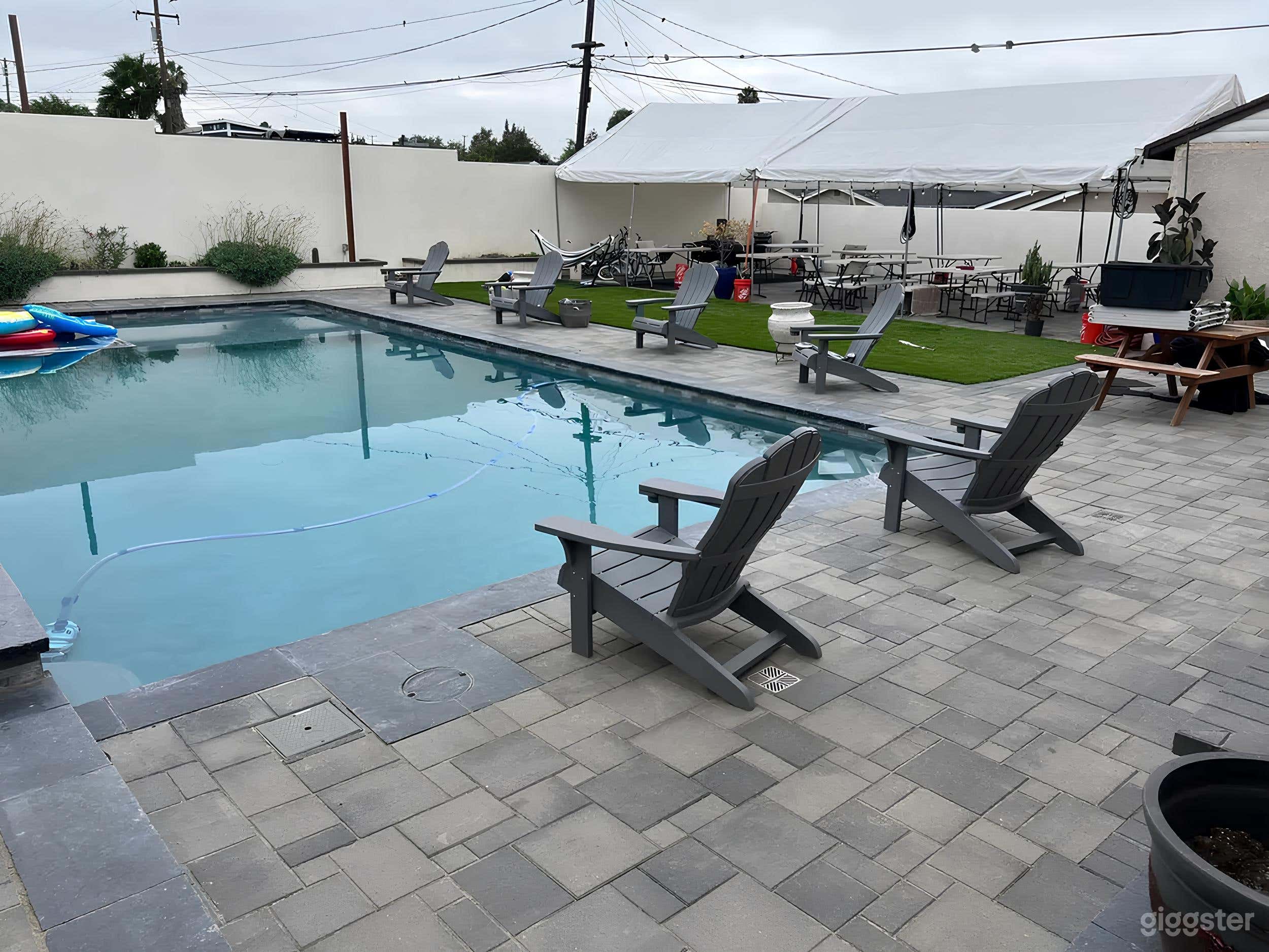 Stylish Pool Lounge with Fire Pit and Covered Seat Photo 1