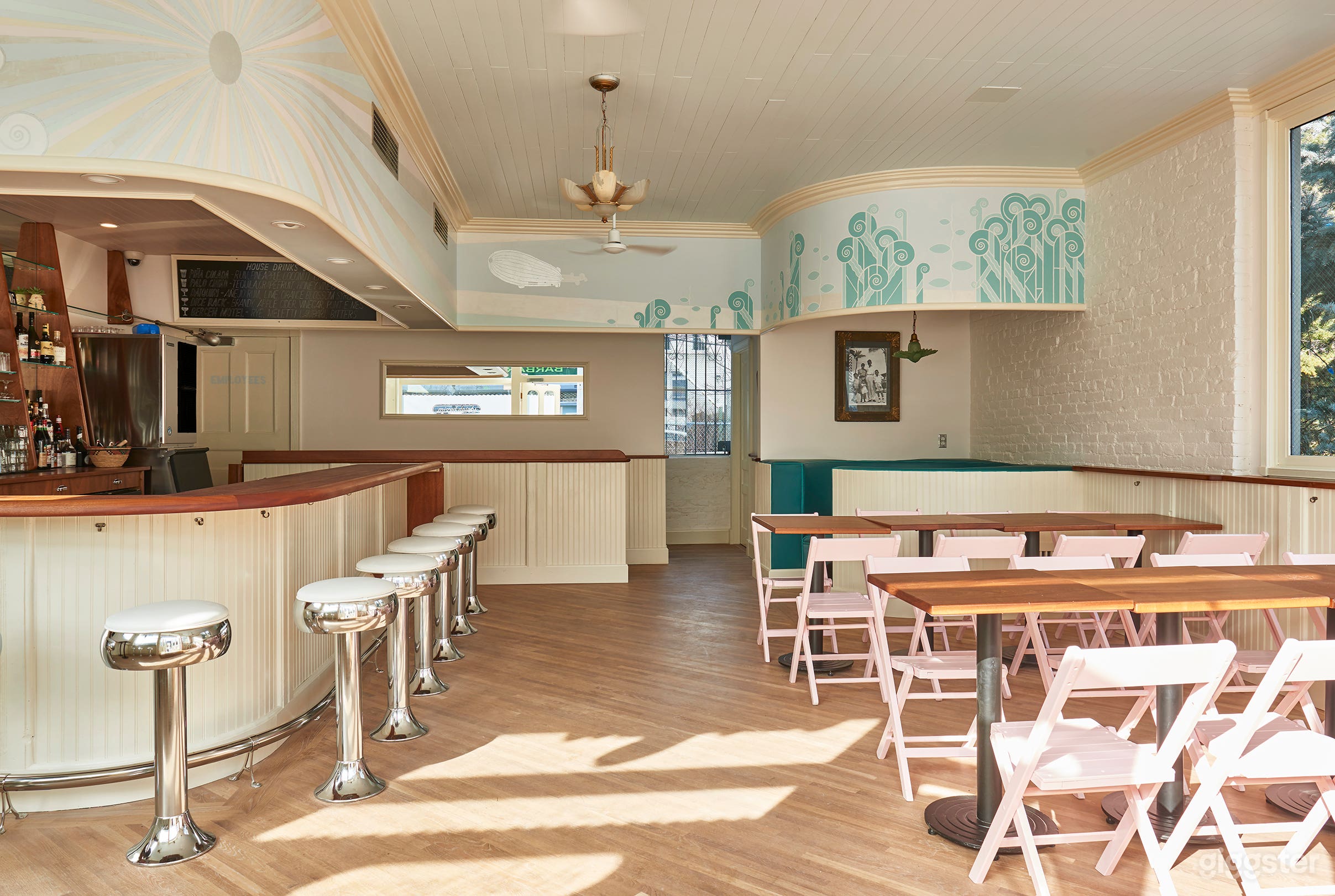 The fixed bar stools lend a retro Ice Cream Parlor feel while the tables &amp; chairs on the right can be moved for more production space.