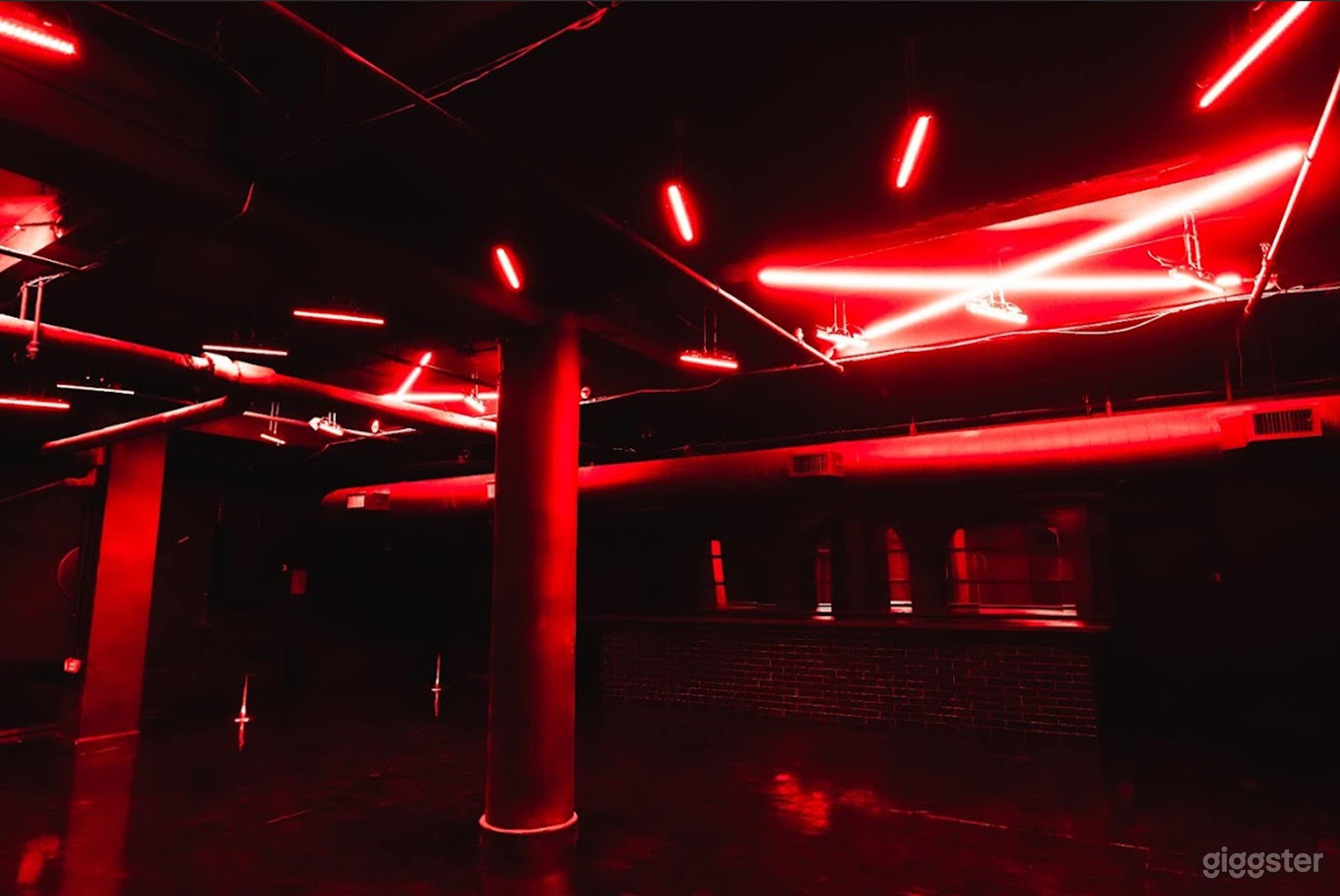 Intimate Speakeasy Cellar with Neon Glow &amp; High-Impact AV Photo 3