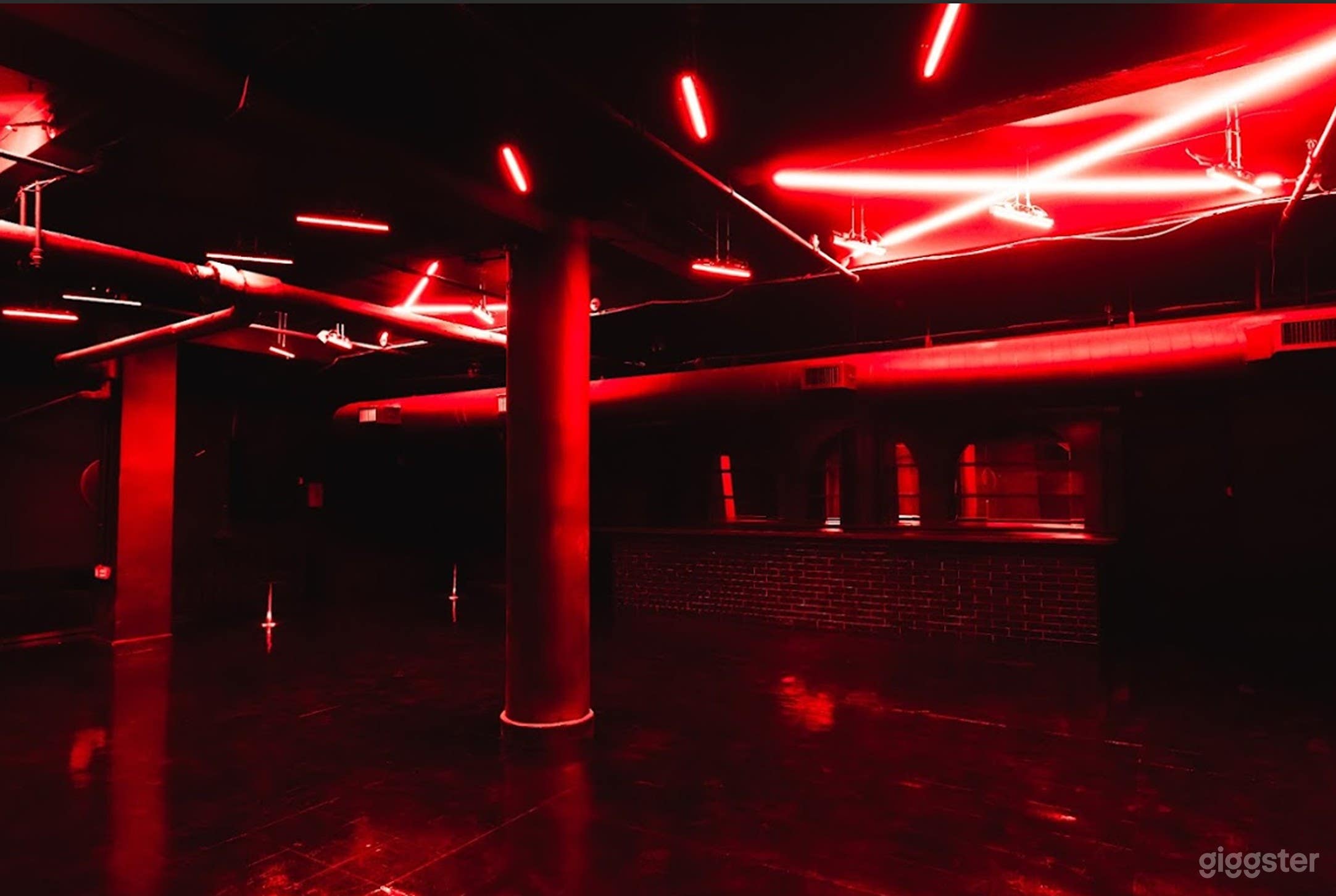 Intimate Speakeasy Cellar with Neon Glow &amp; High-Impact AV Photo 2