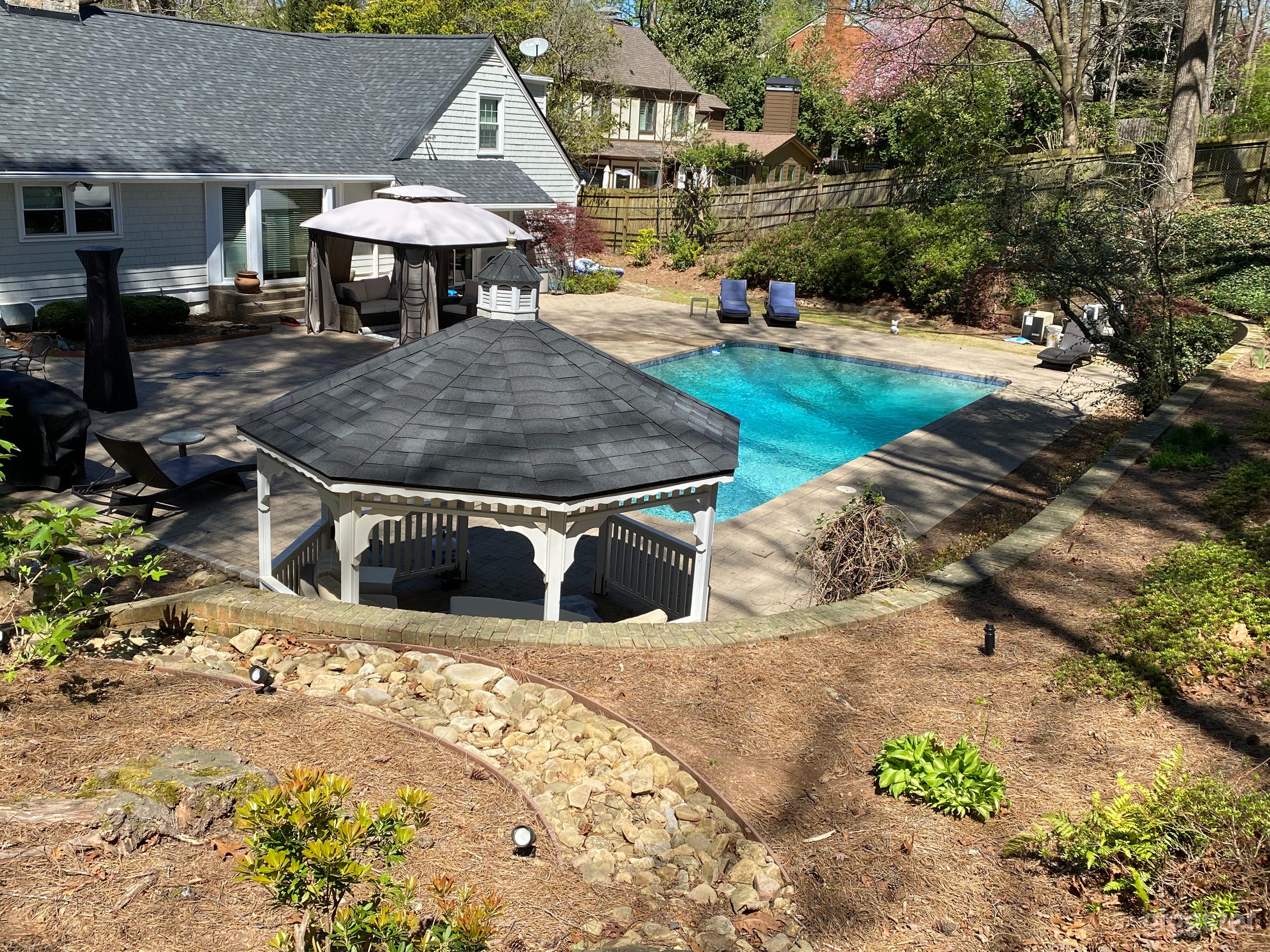 Beautifully landscaped yard and gazebo frame the pool!