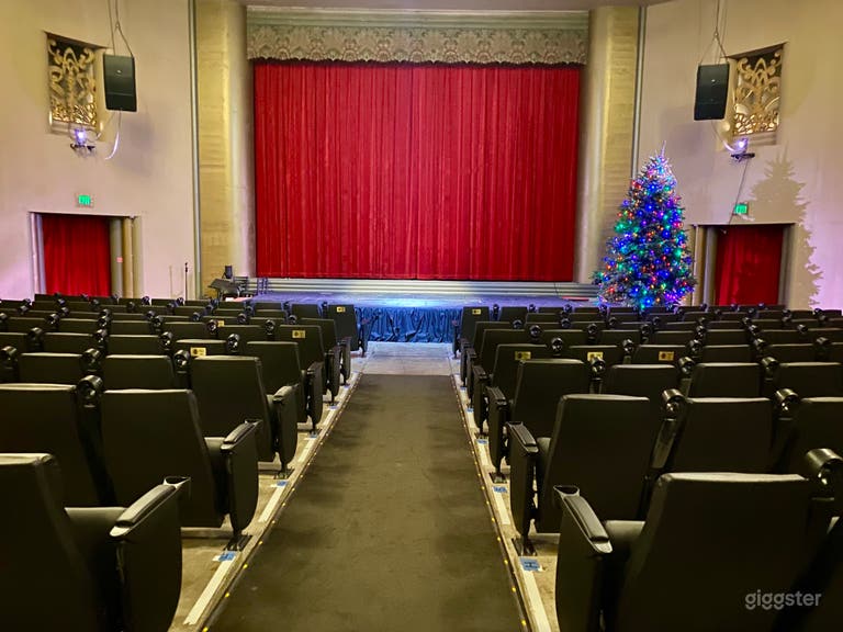  Inside of the auditorium view of stage and red curtains.  