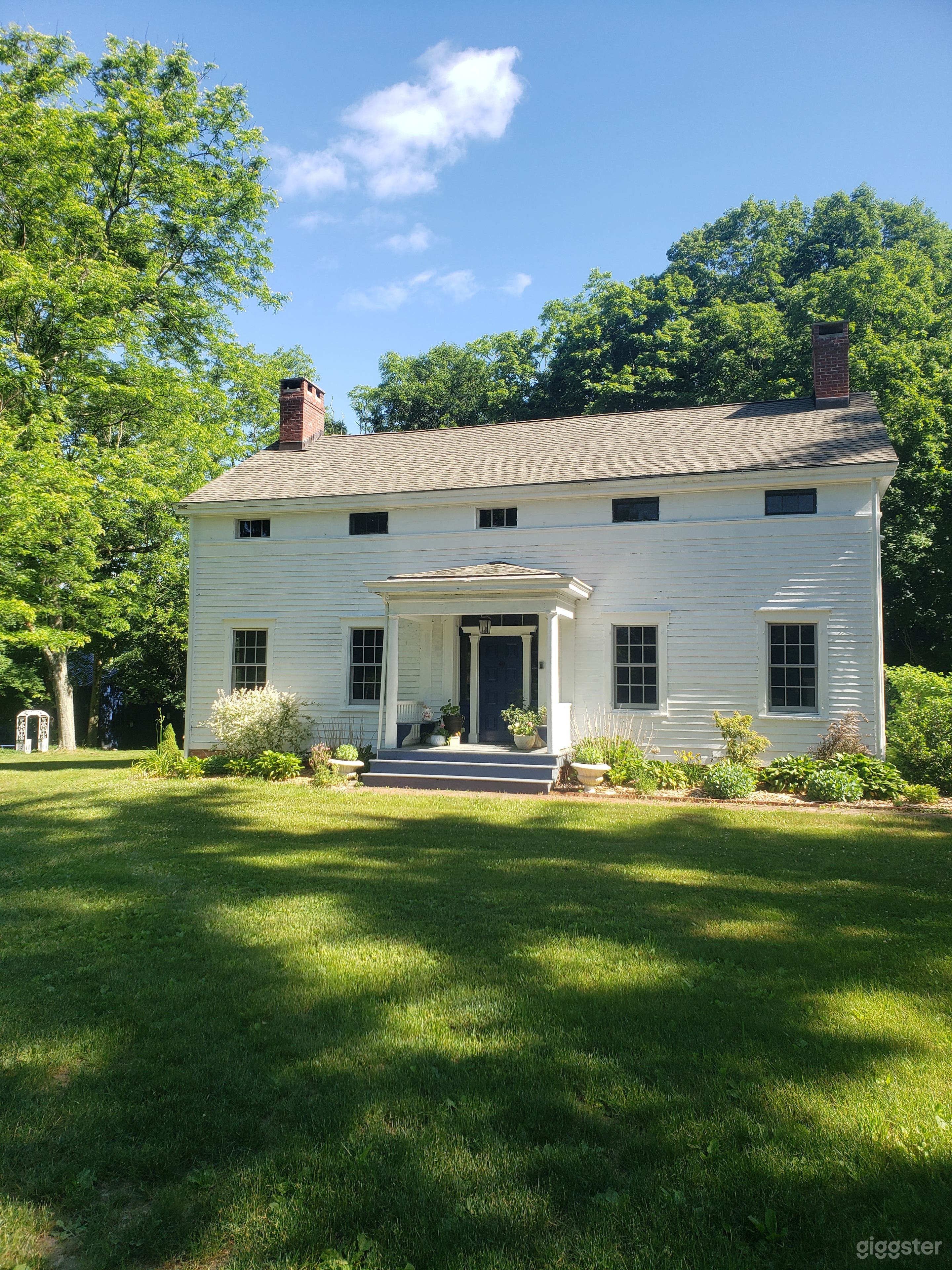 Our 1840s eyebrow colonial with brick walkway and serene garden.