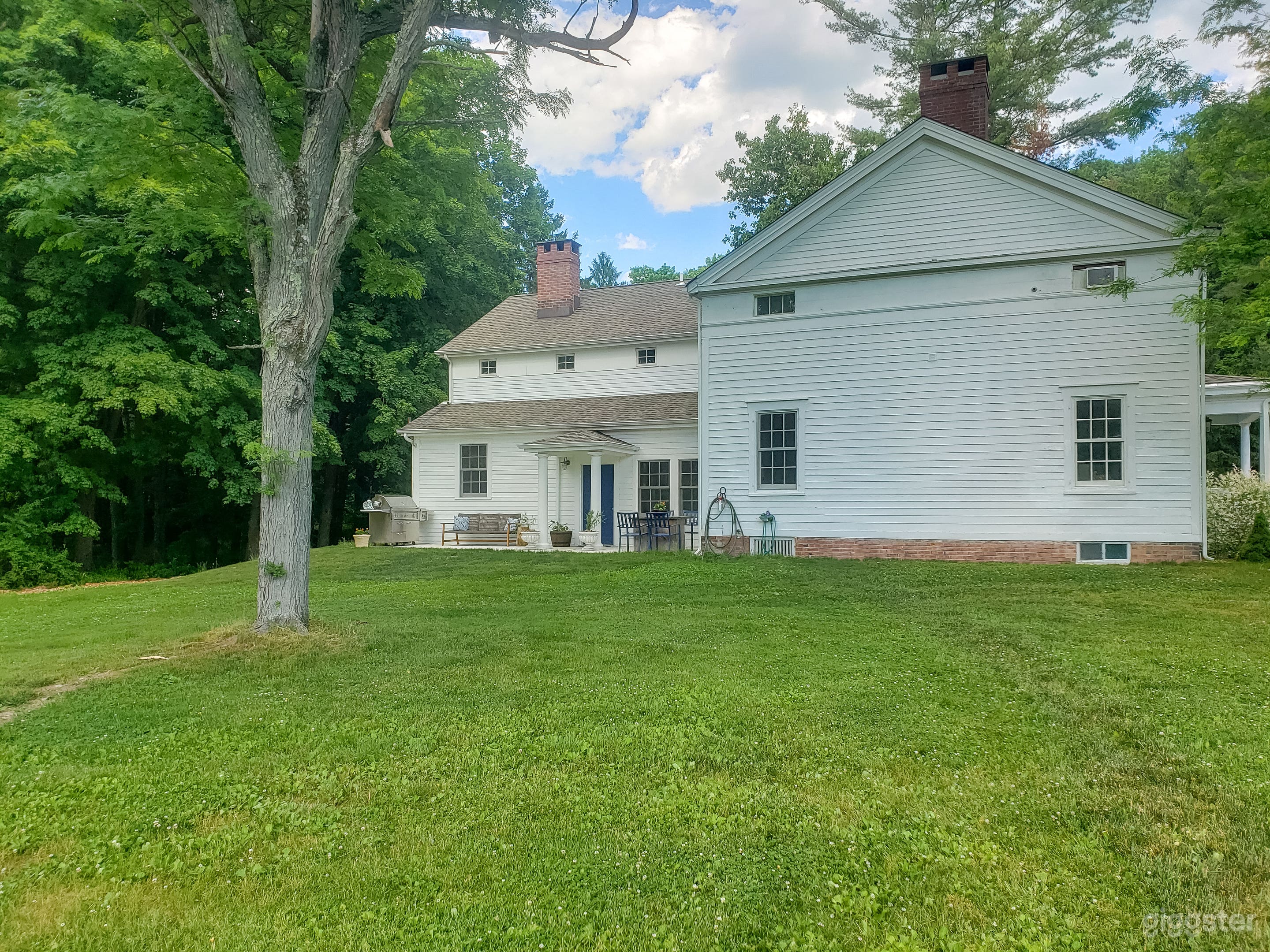 Part of the backyard plus our patio connected to the eyebrow colonial house.