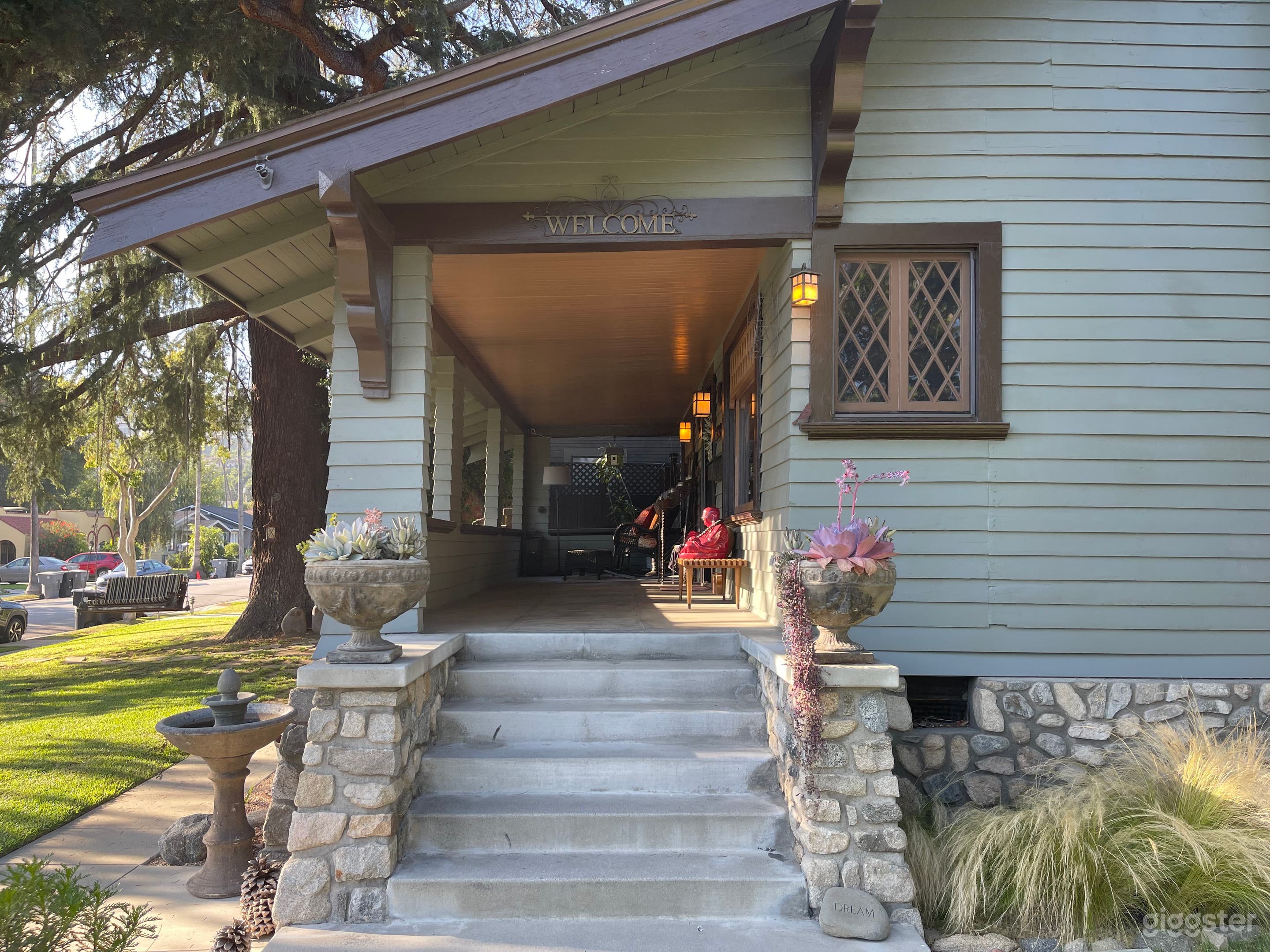 Entrance features local river rock foundation, vertical clapboard siding, original gables and diamond windows.