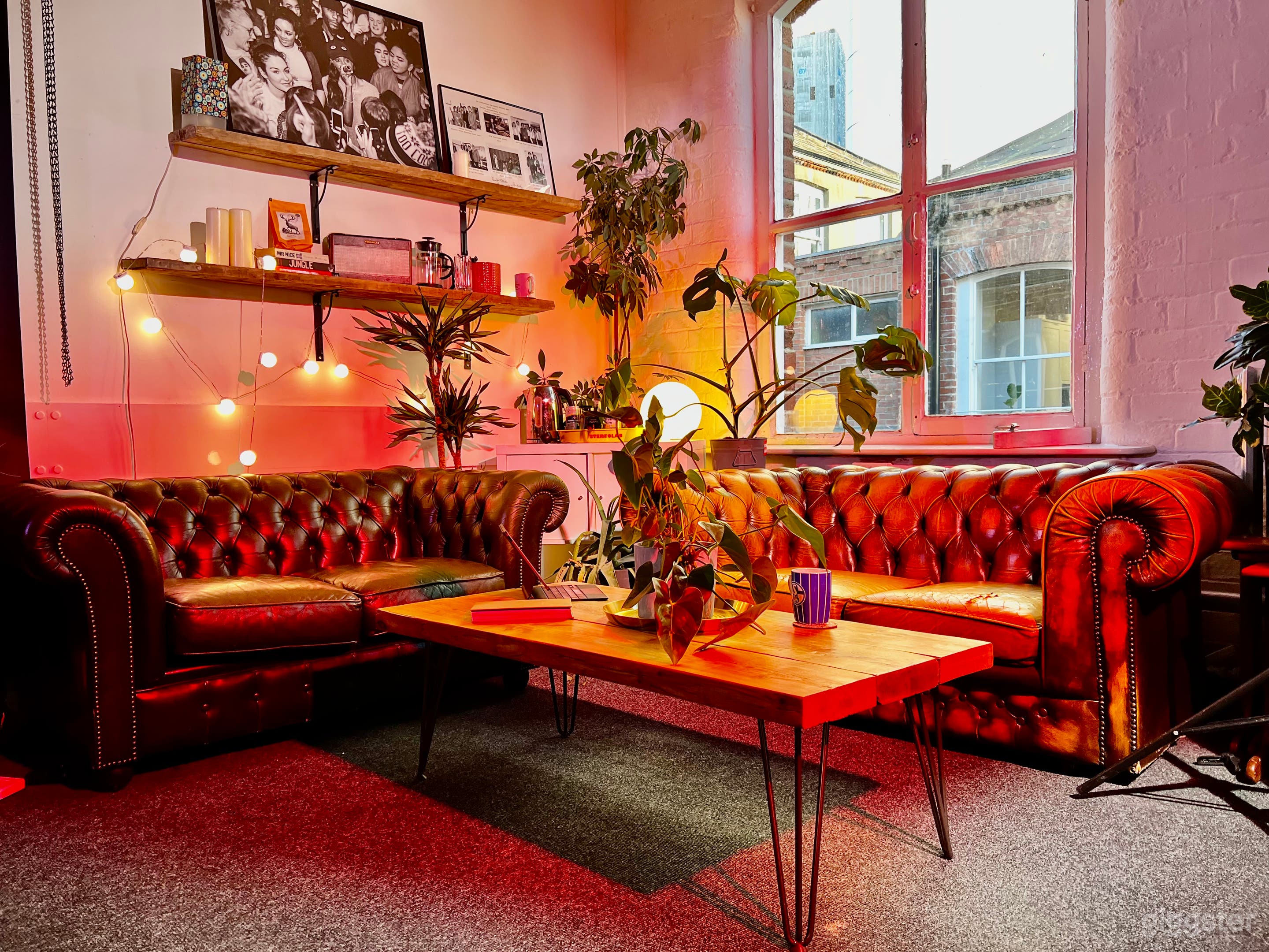 Cosy loft style studio with loads of video lighting grip and camera equipment.