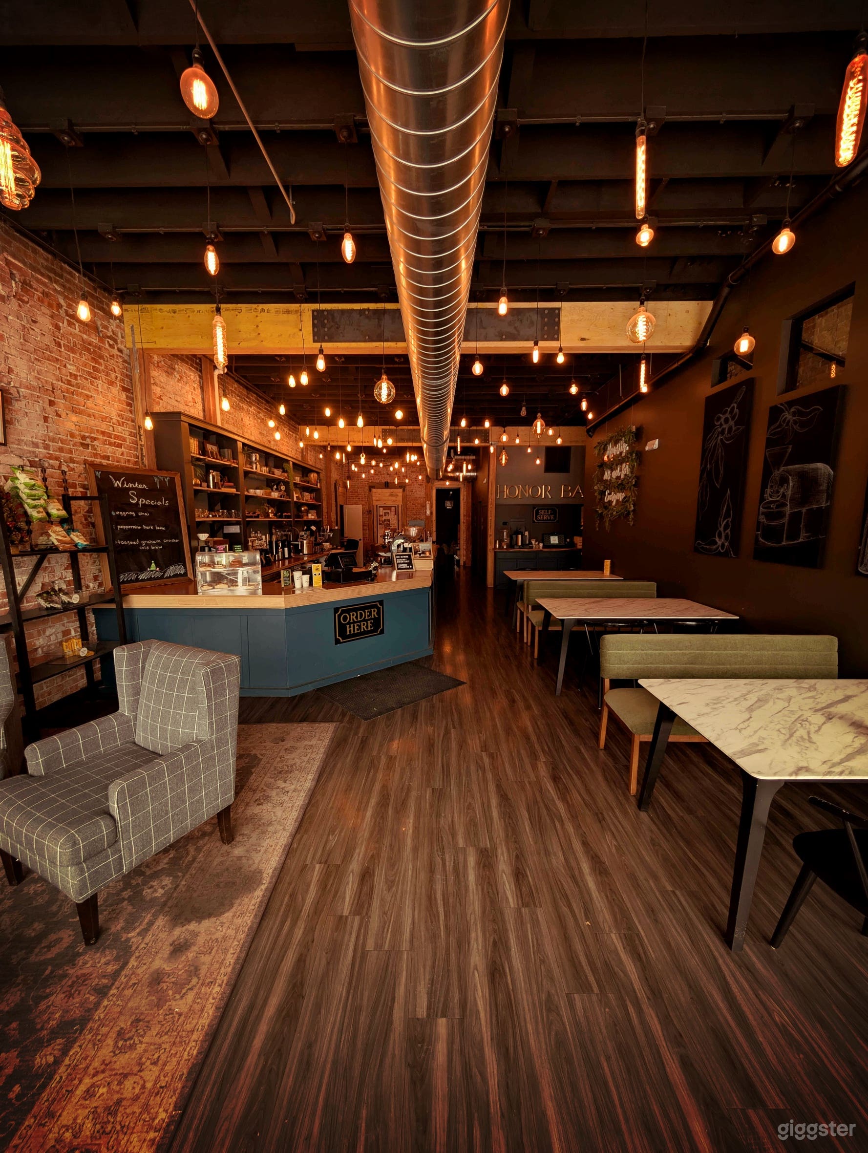 Cozy/Ambient coffee shop, warm lighting, brick interior Photo 3