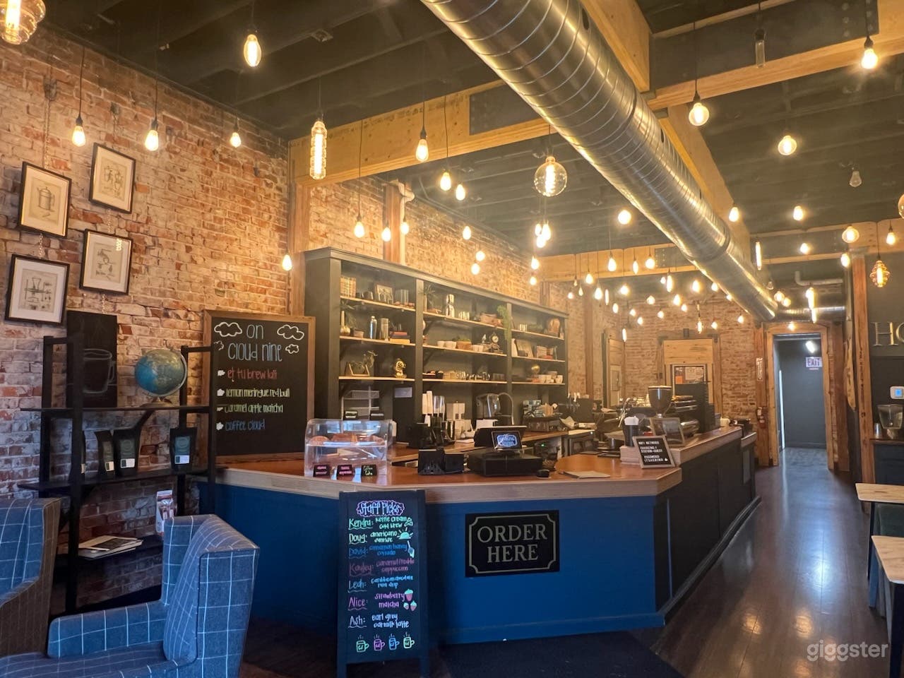 Cozy/Ambient coffee shop, warm lighting, brick interior Photo 4