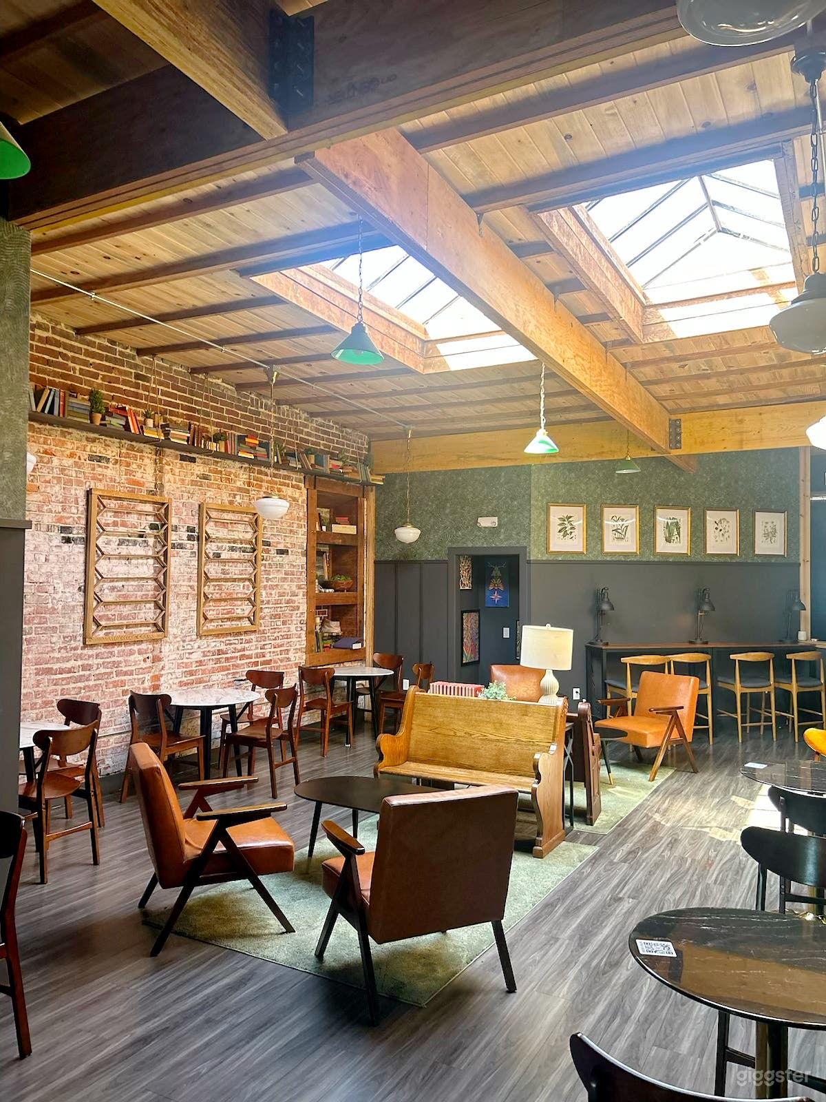 Cozy/Ambient coffee shop, warm lighting, brick interior Photo 1