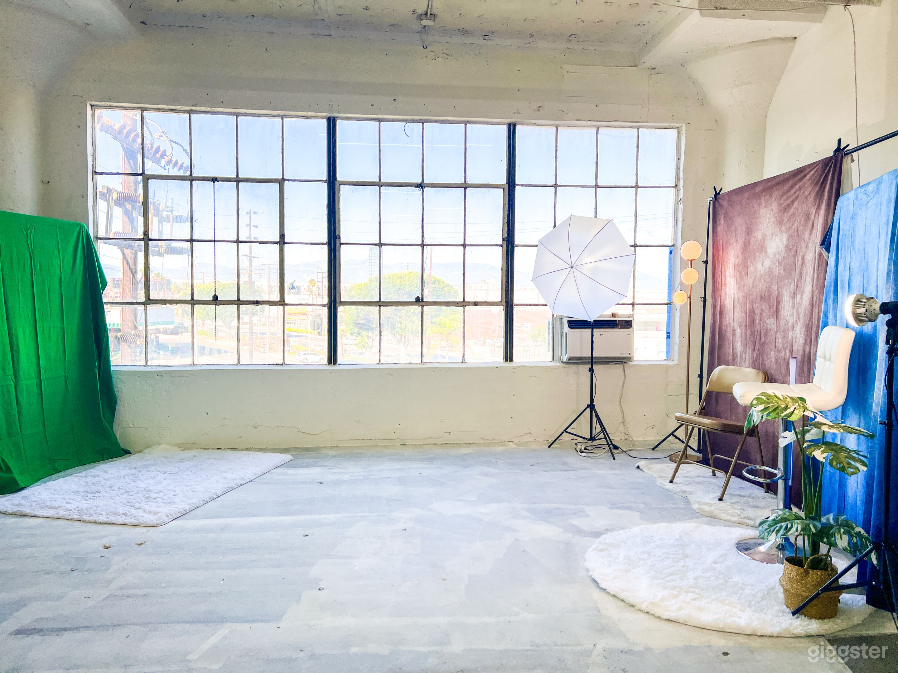 Bright natural light studio with multiple back drops and green screen