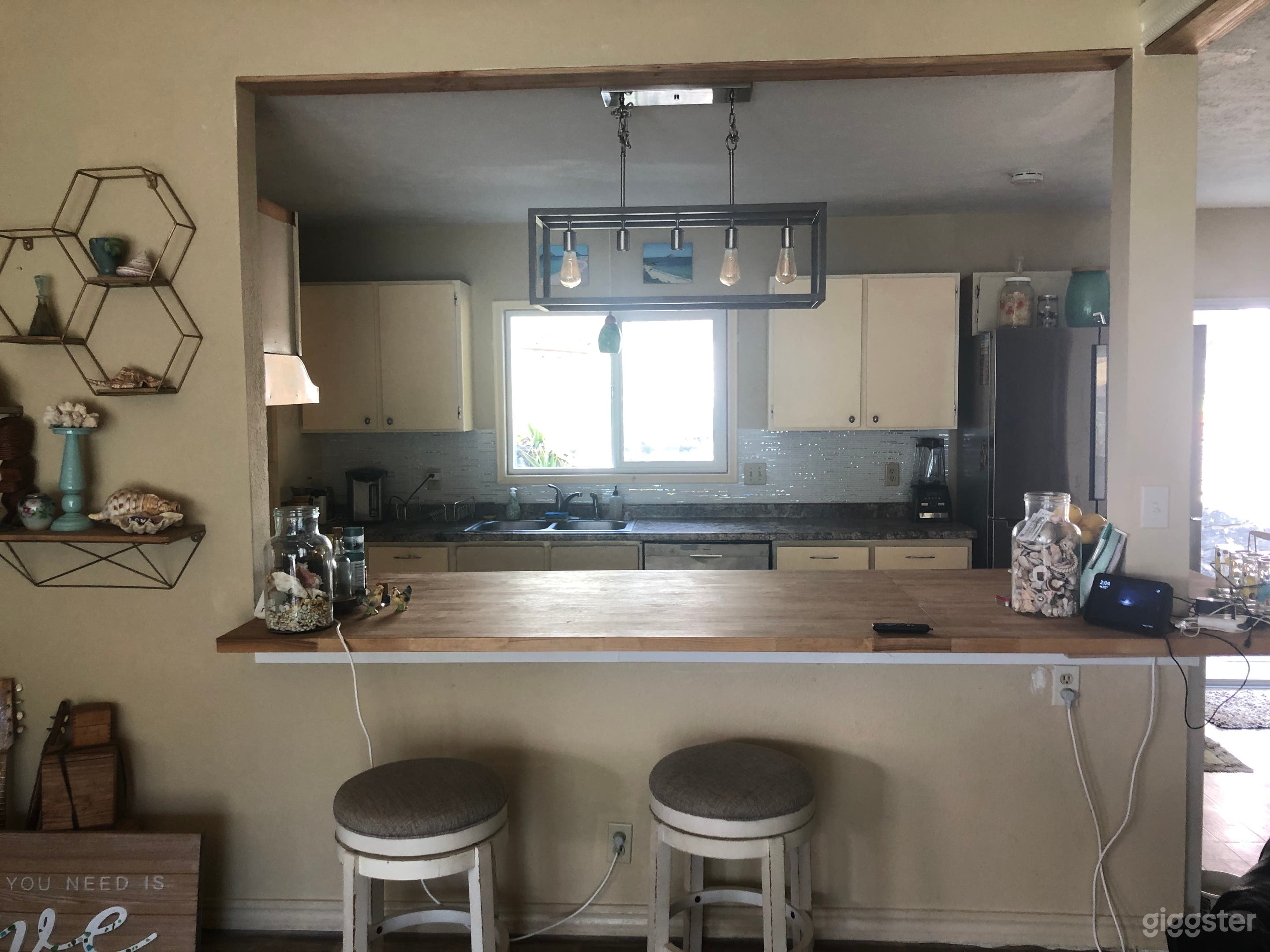 Open kitchen with butcher block island and seating.