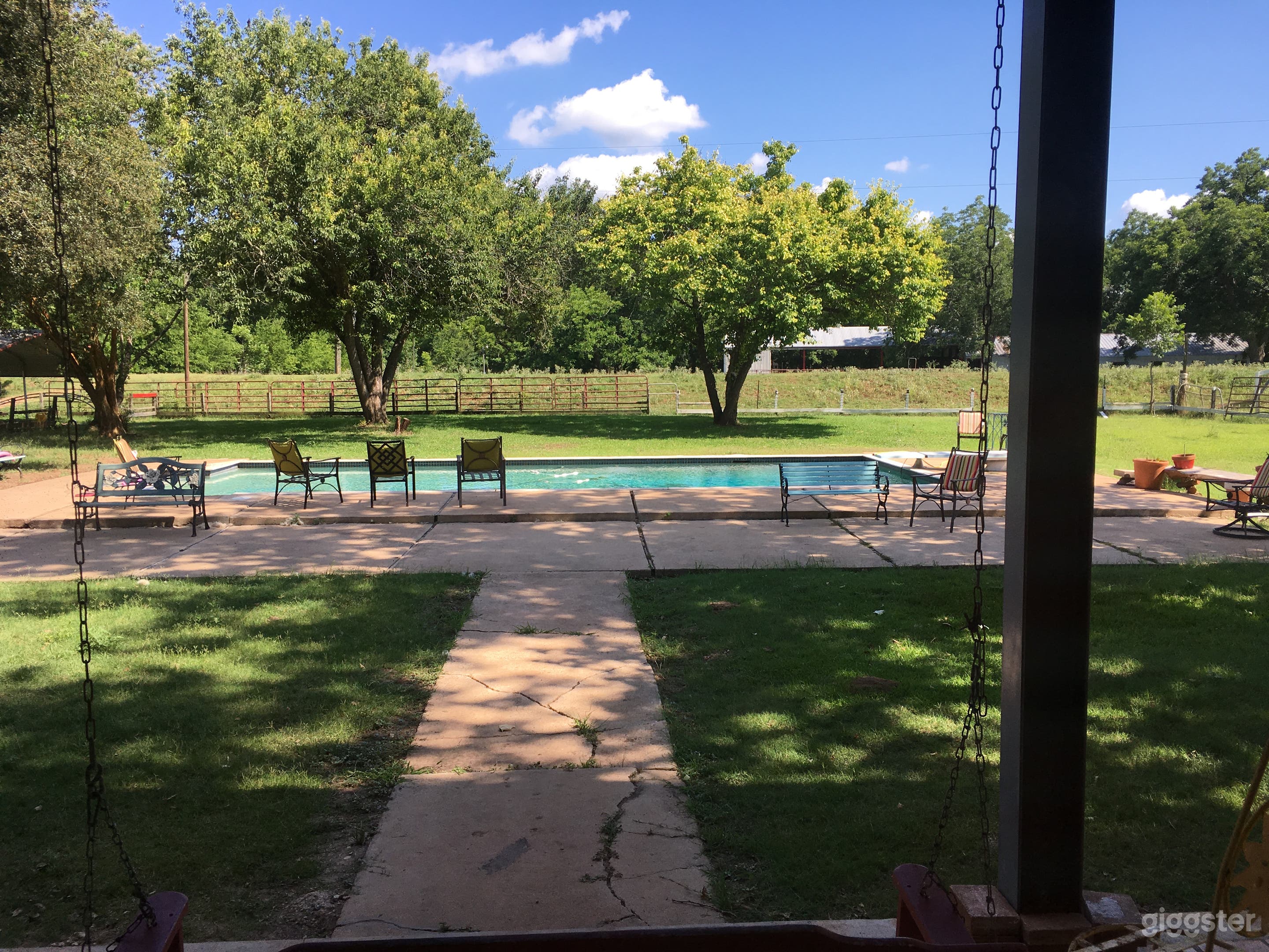 View of backyard, pool and barn in background. 