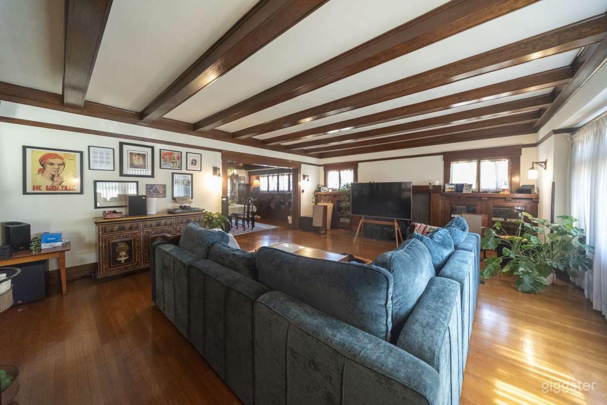 Living Room with exposed beams and original built-in wood cabinetry. 
