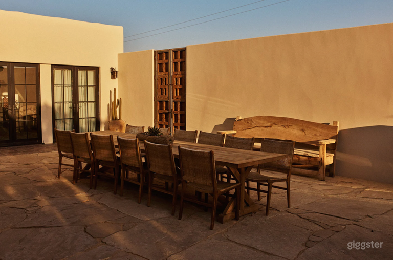  Courtyard view with large outdoor dining table. 