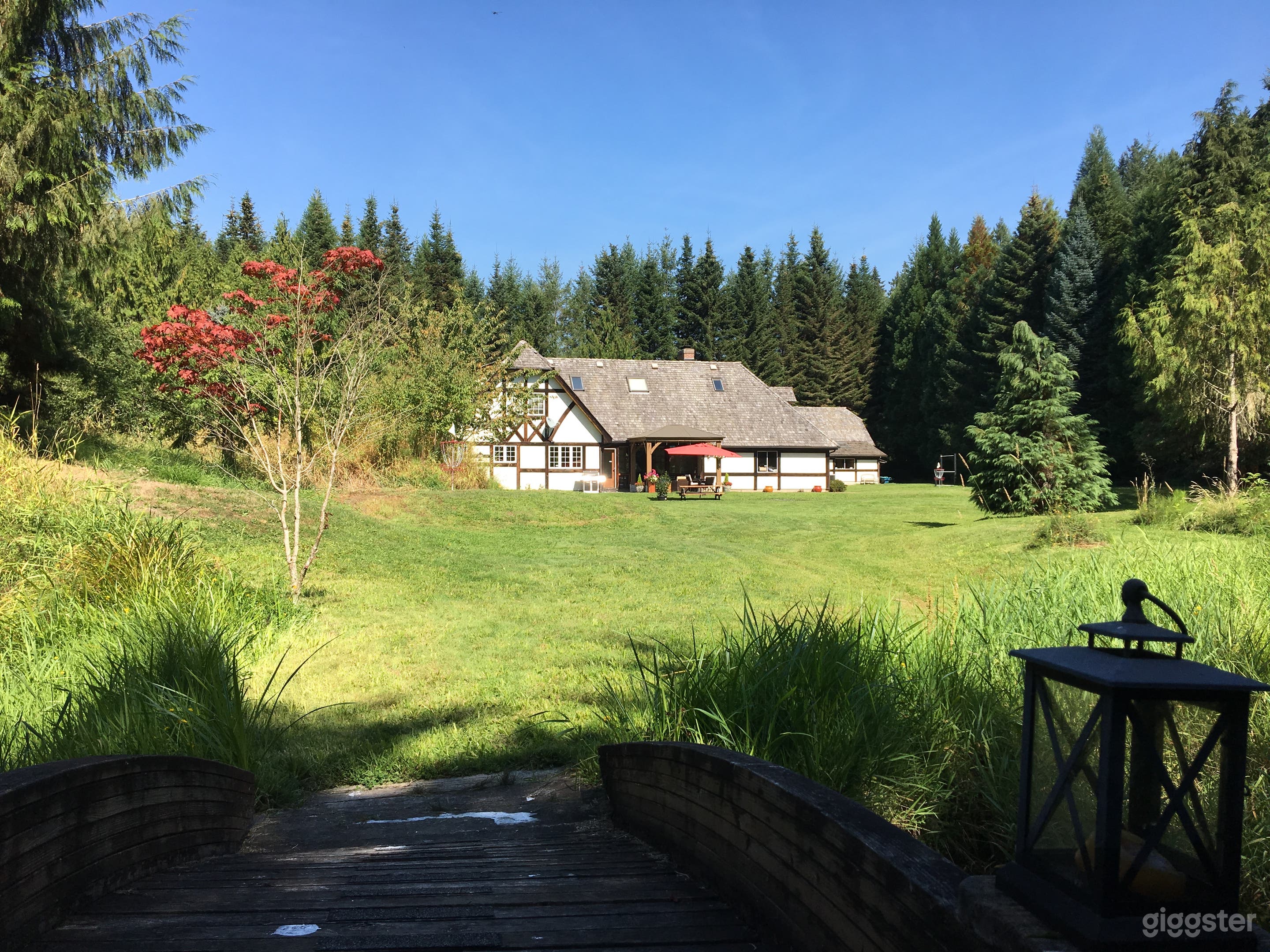 Tudor home in the woods with large pond Photo 2