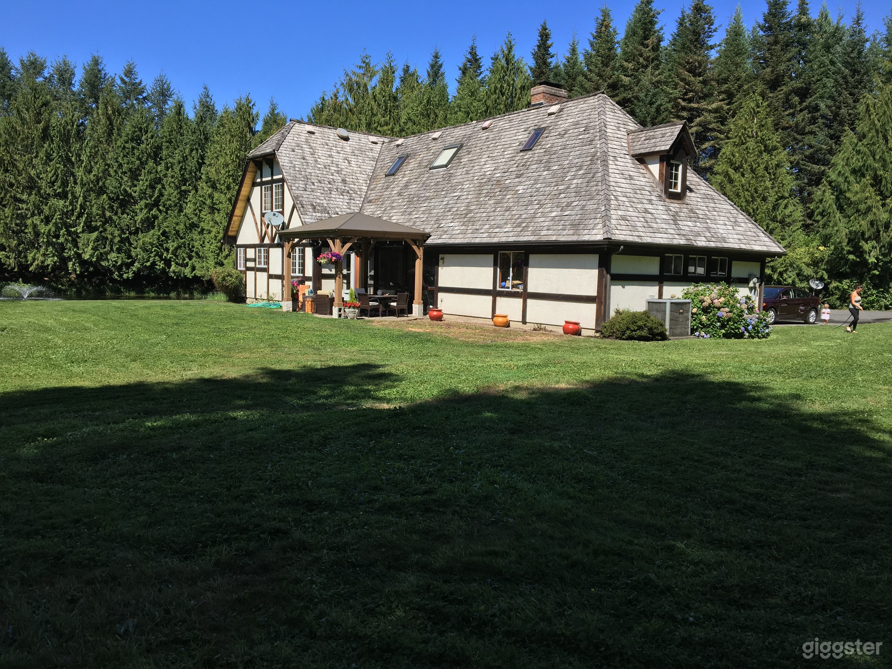 Tudor home in the woods with large pond Photo 3