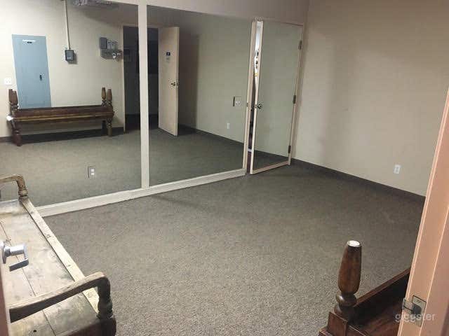 Clean, Carpeted Yoga Room with One-Mirrored Wall  Photo 1