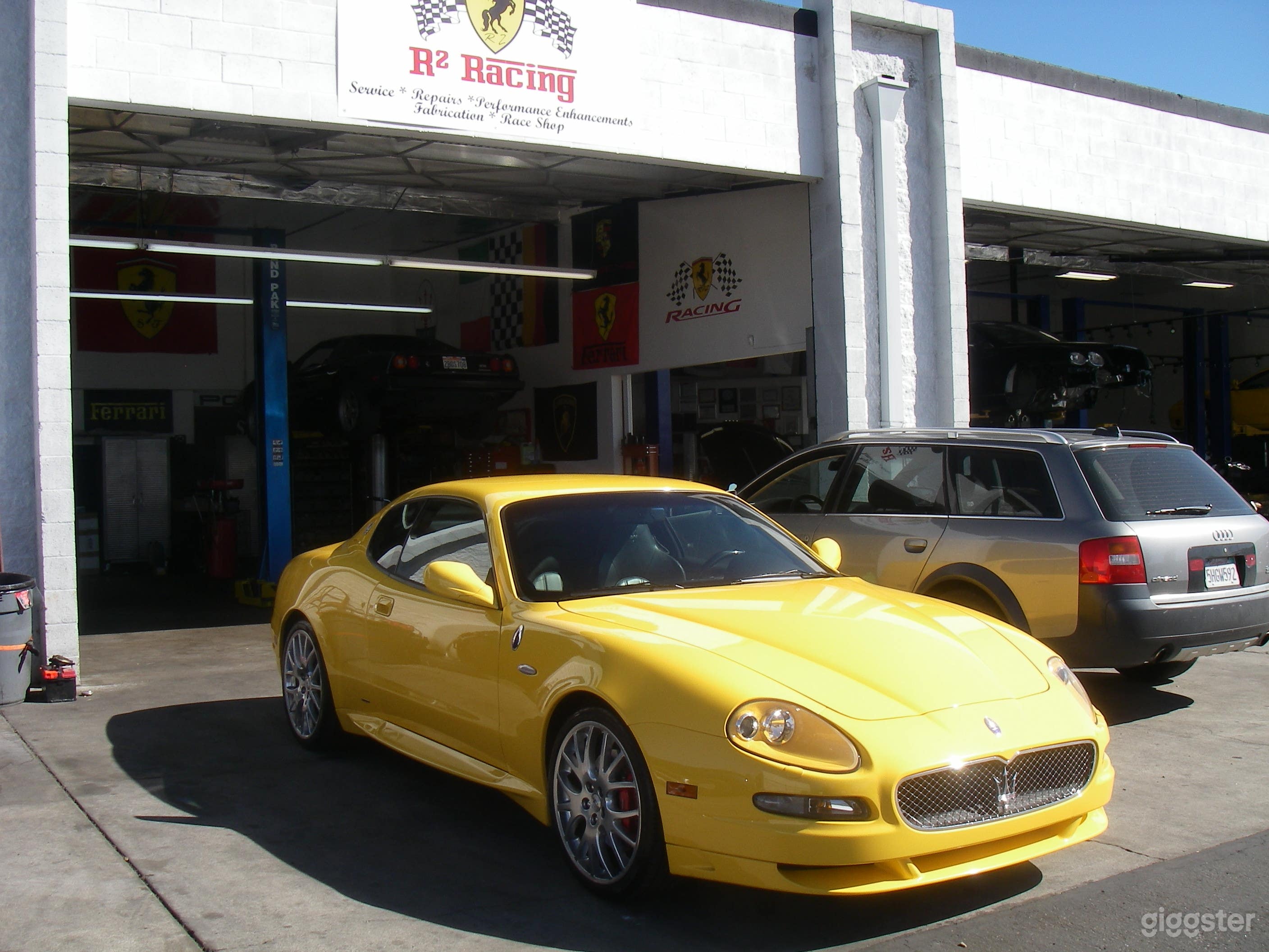 exotic car shop 4 bays, always loaded with Ferraris, Porsches, Maseratis, Lamborghinis