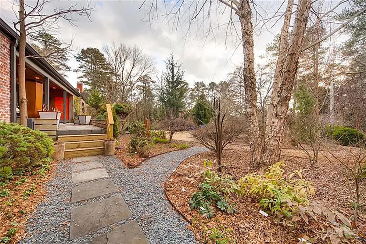 Lush front yard with slate walkway. Plenty of room for crew. Japanese maples and year round grennery. Stone bench with fire pit and sitting area. 