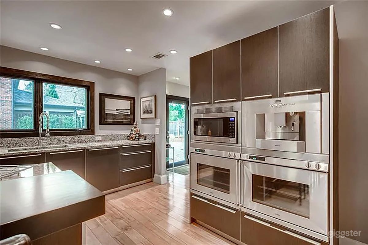 Modern kitchen with European appliances , marble counters and spacious layout.