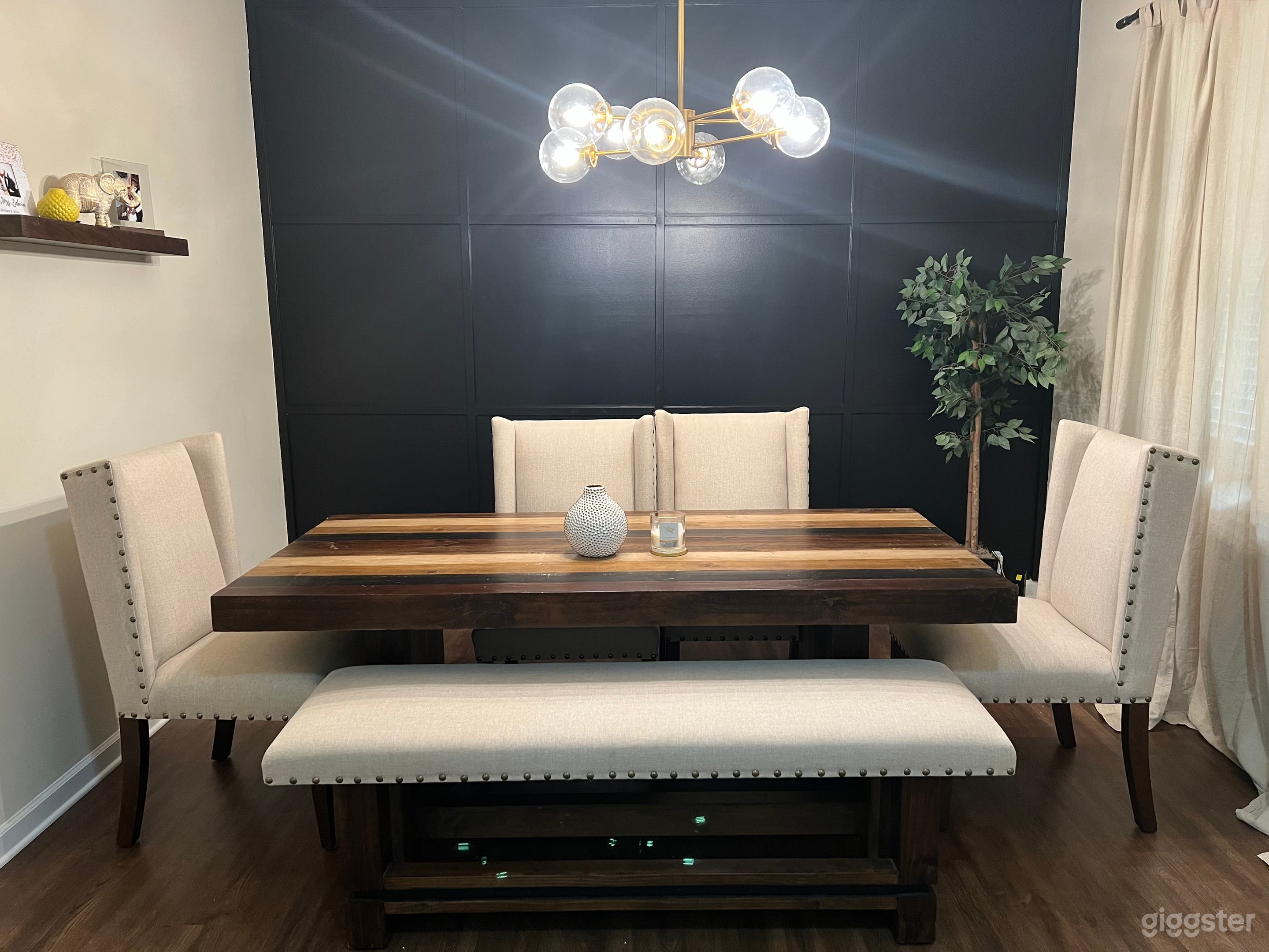 Formal dining room with black accent wall. 