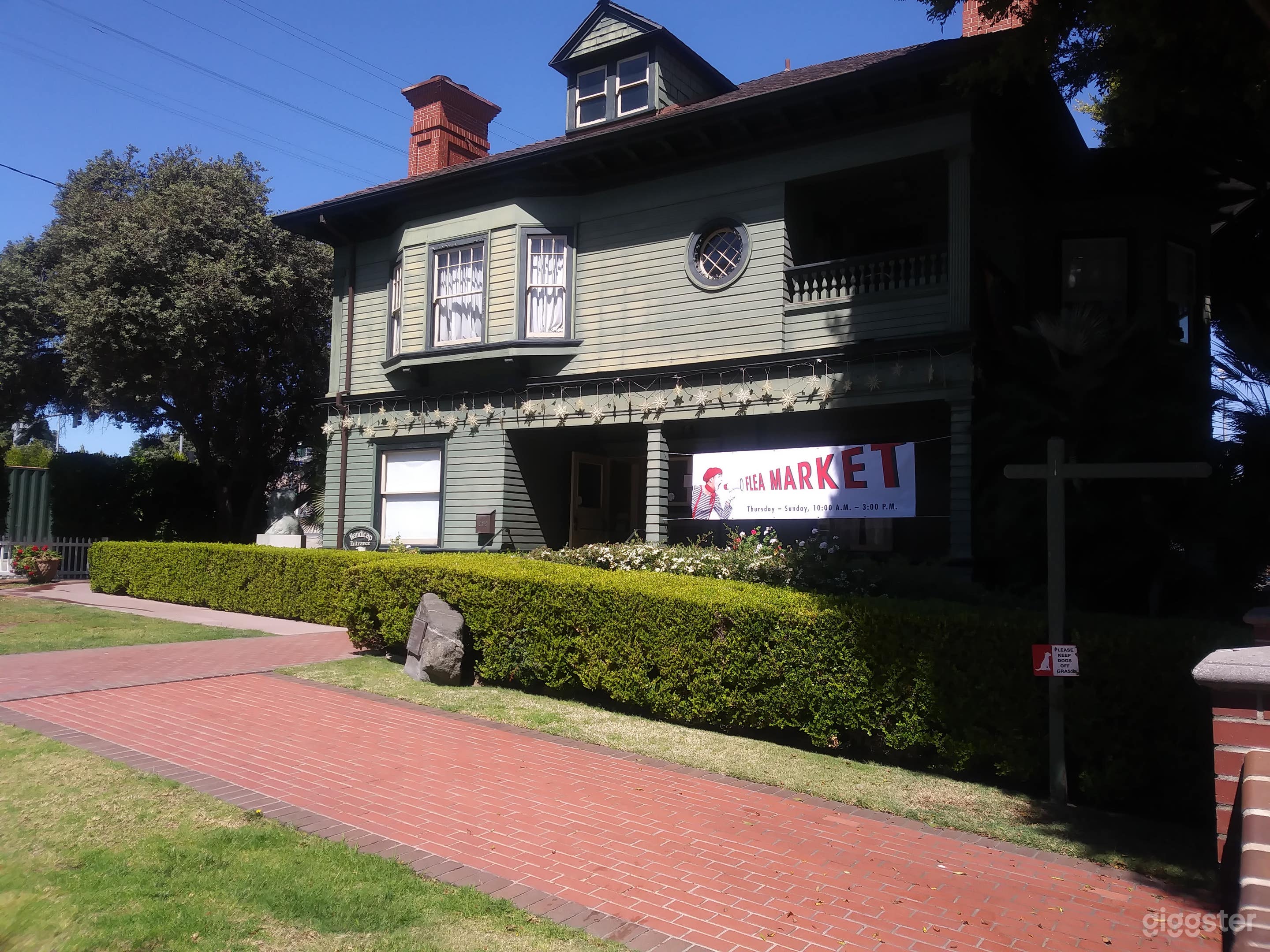 Side angle of turn of the century two story museum with beautiful brick walkway