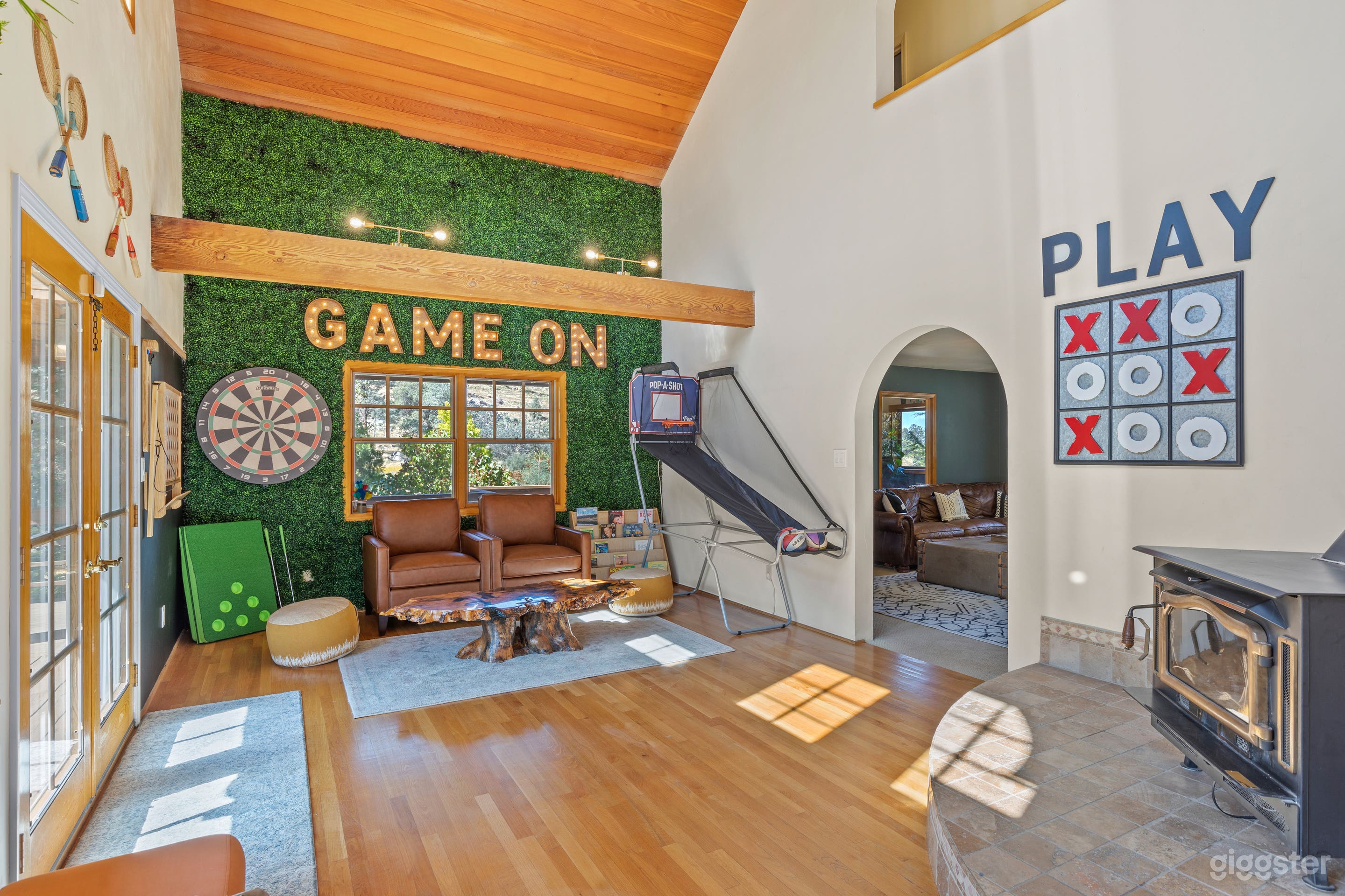 Game room with vaulted wooden ceilings and beams