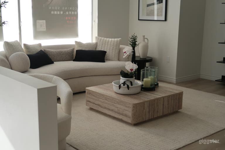  Modern reception with a plush couch, water dispensers, and a welcoming, stylish atmosphere for guests and clients. 