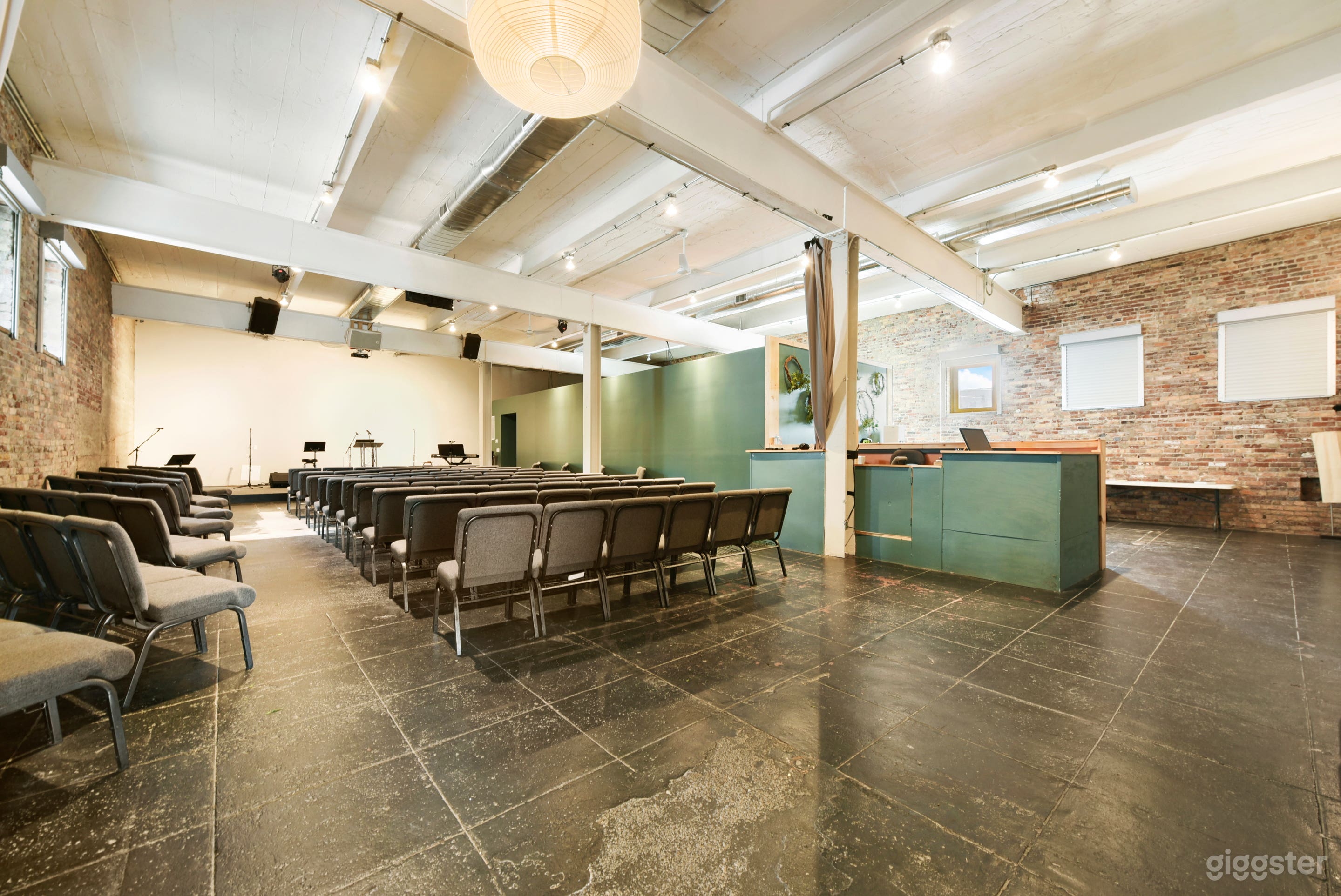 Open floor plate with exposed brick, exposed beams, polished concrete floors