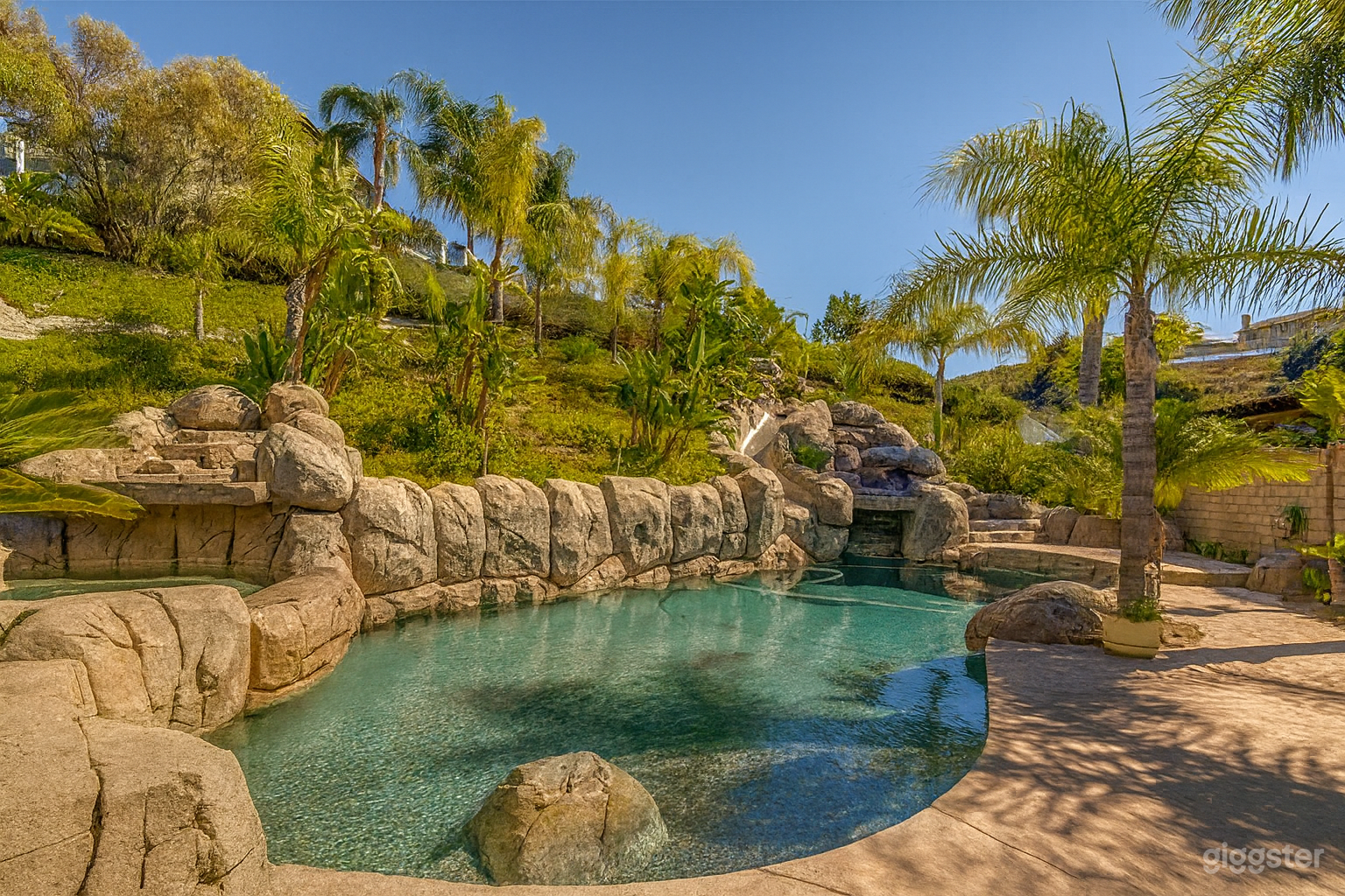 Luxury Tropical Backyard with Waterfall Pool & Palm Tree Photo 1