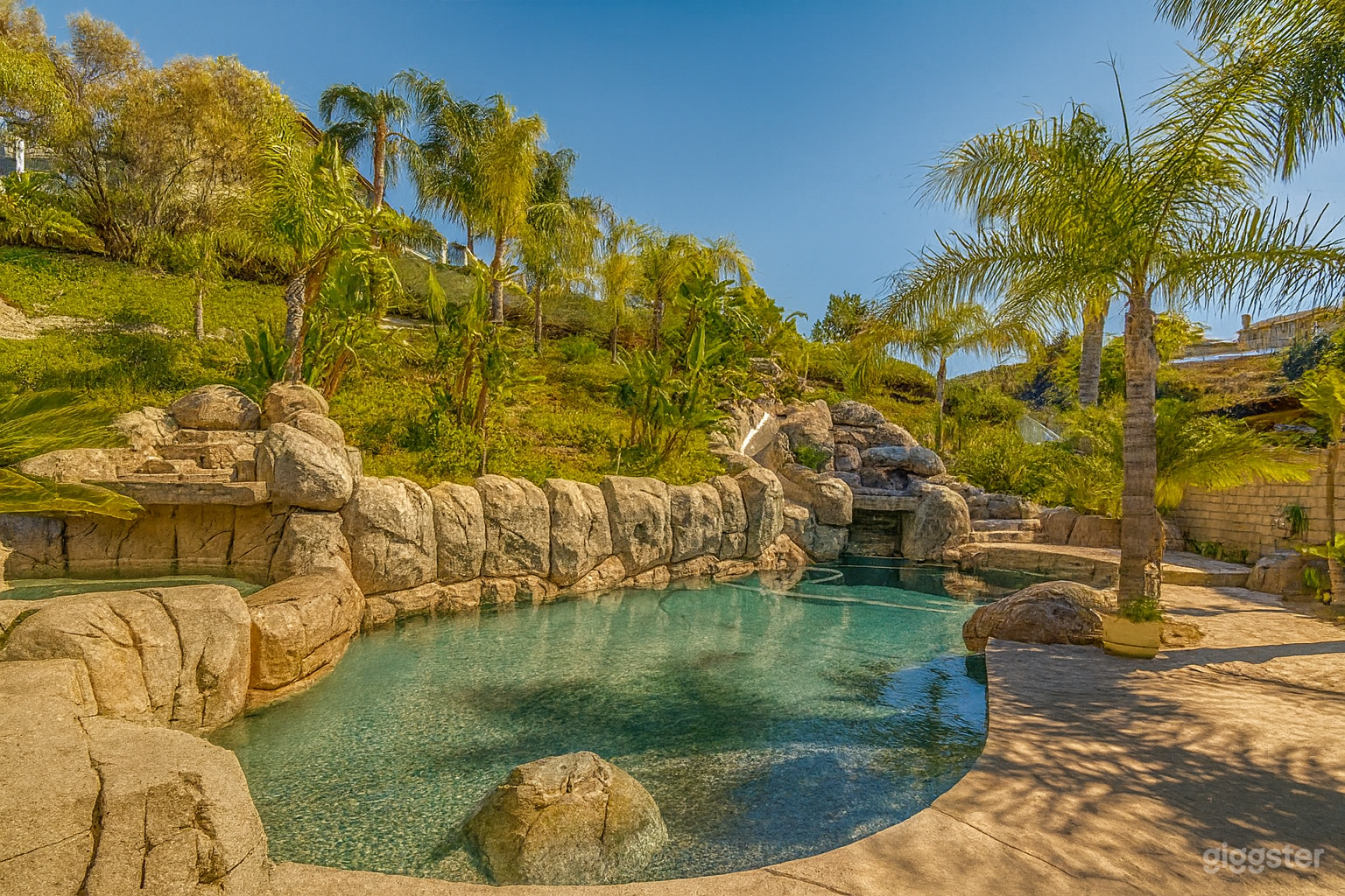 Luxury Tropical Backyard with Waterfall Pool & Palm Tree Photo 4