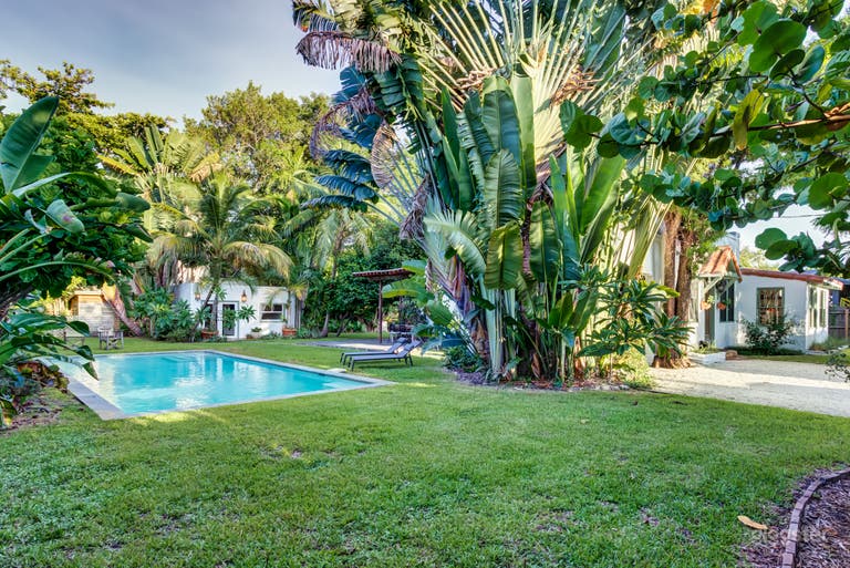  Large yard with swimming pool and lush tropical landscaping.  