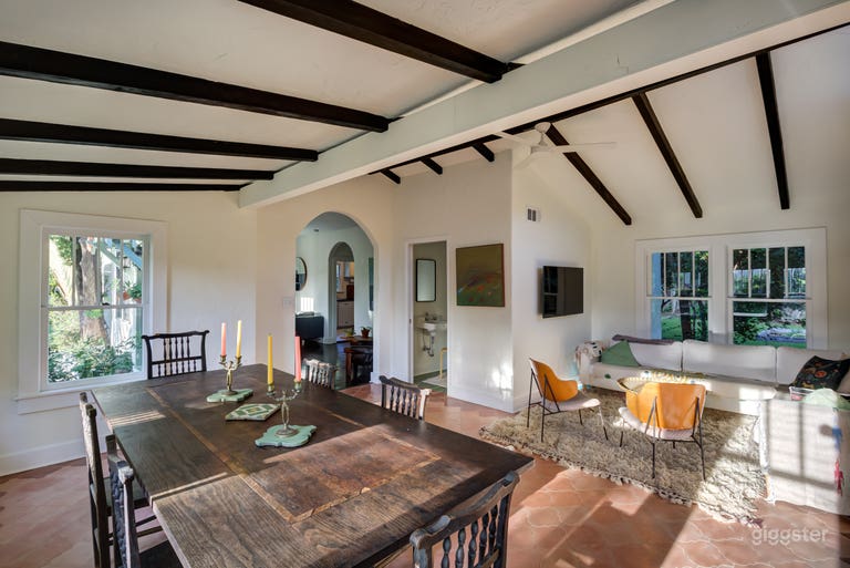  The large living/dining area features arched entryways, wood-frame windows, and custom tile.  
