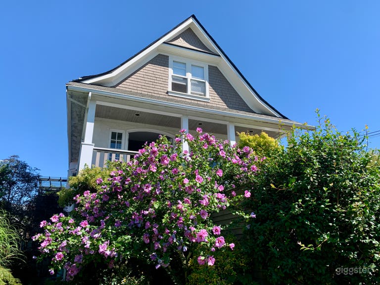  Front of house with hibiscus in summer bloom. 