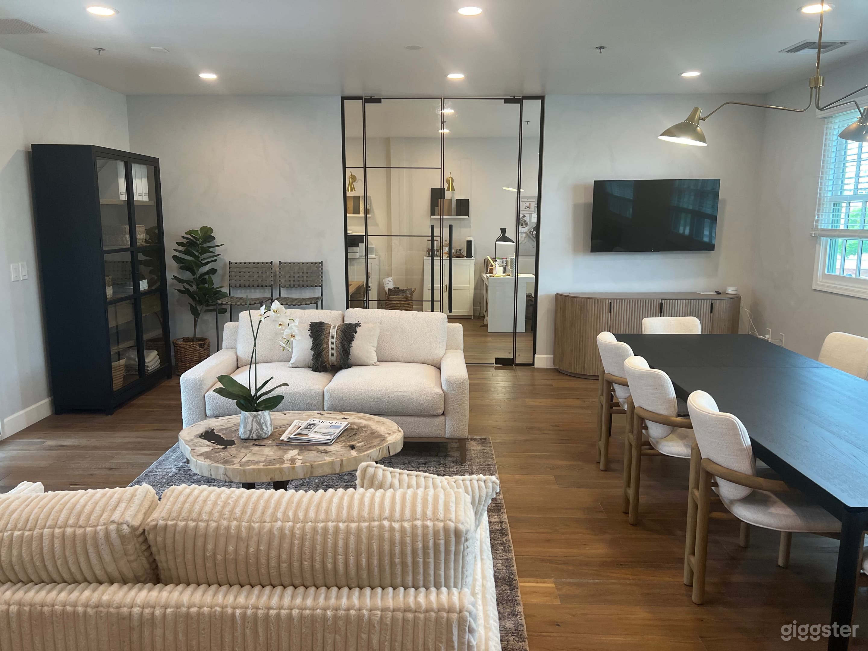 Center space with conference table and lounge. Two private offices at each end of the space. 