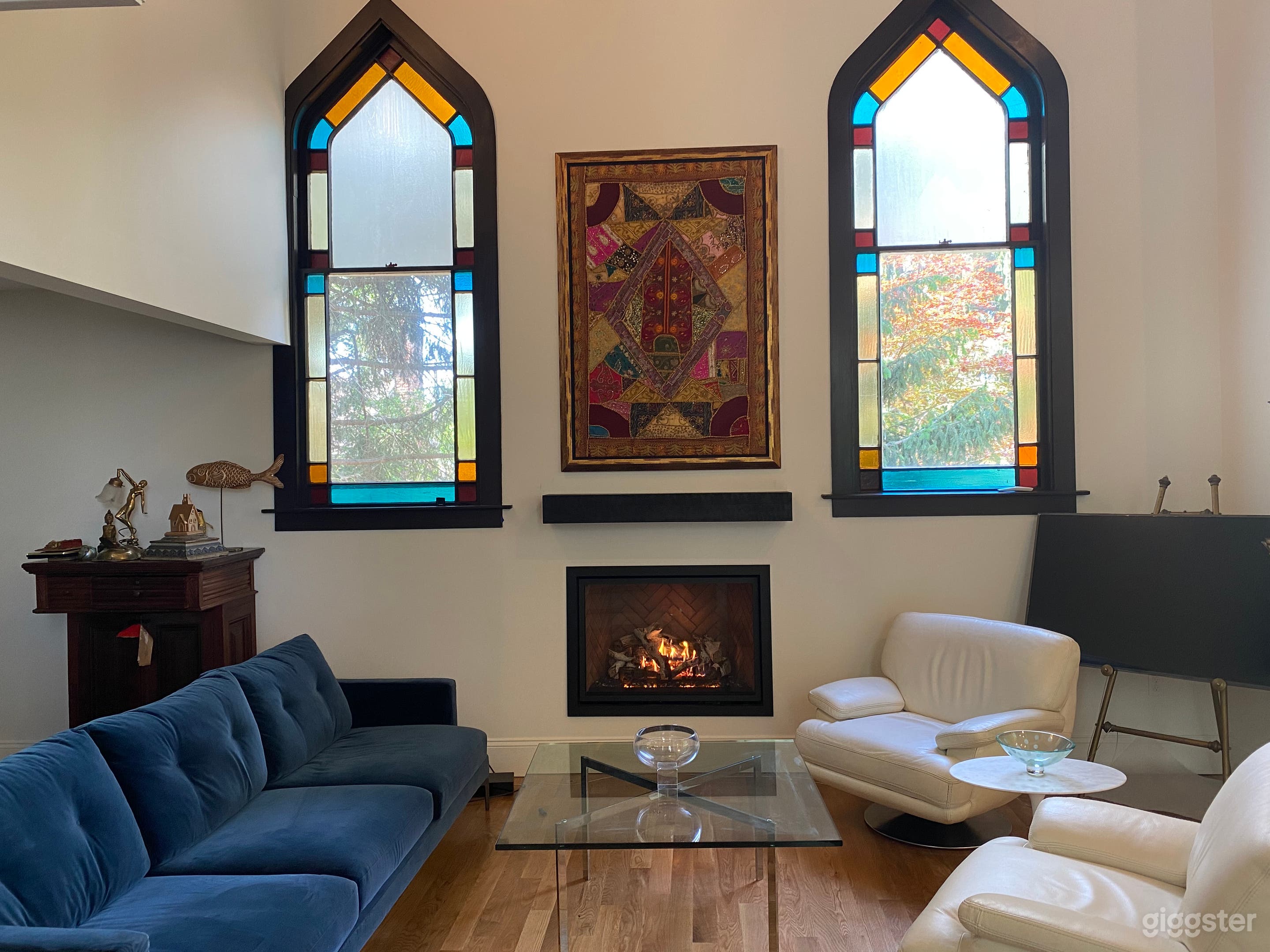Living area with stained glass windows facing West, Modern gas fireplace flush to wall with remote.