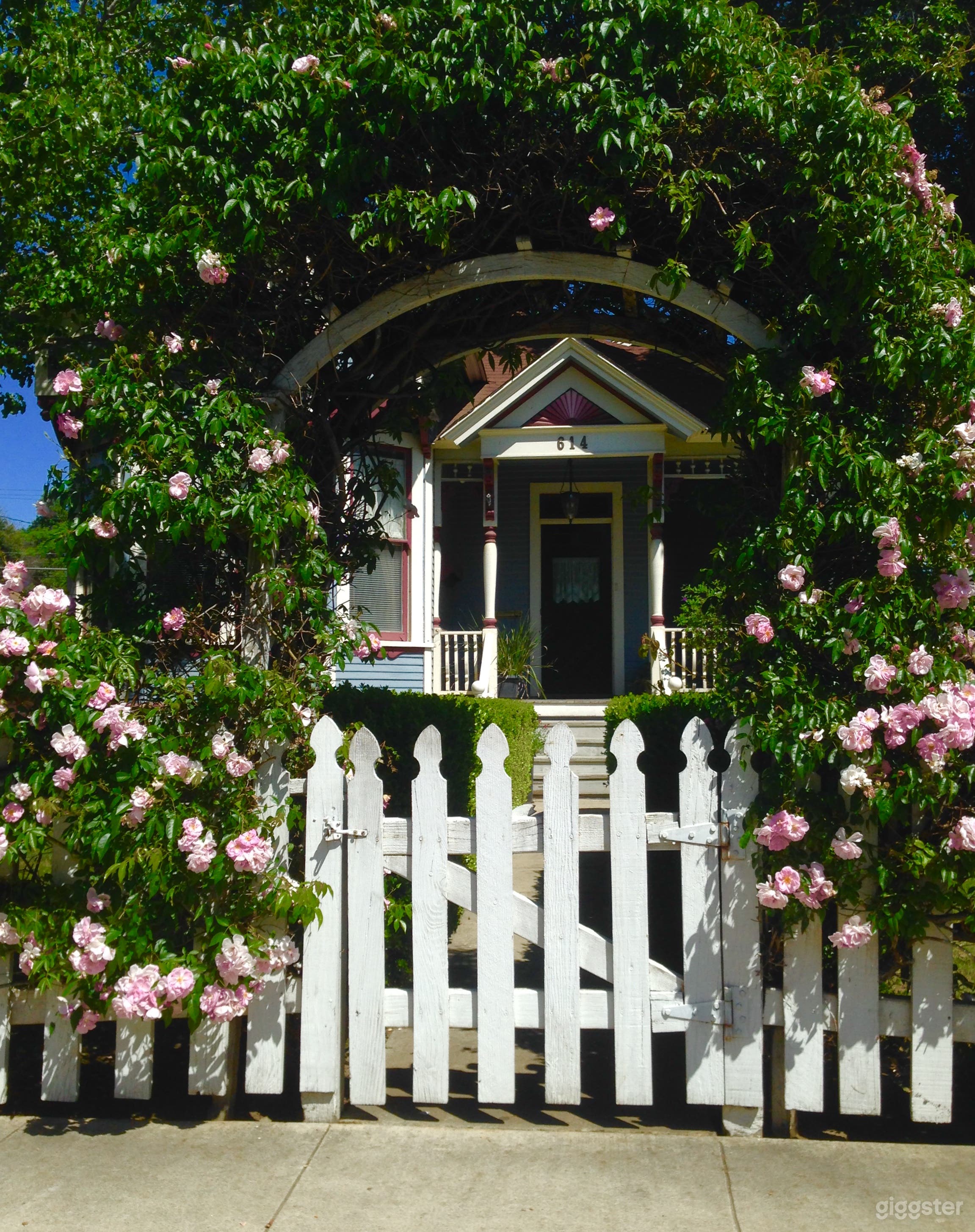 1904 Eastlake Victorian; view of front entrance through rose arbor gate.