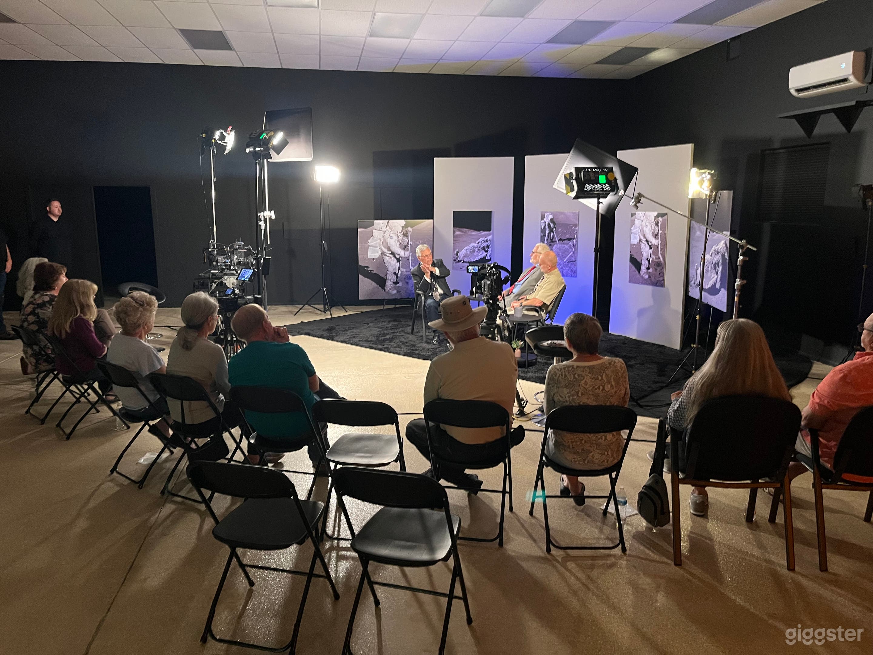 Multi-camera studio shoot with small audience.