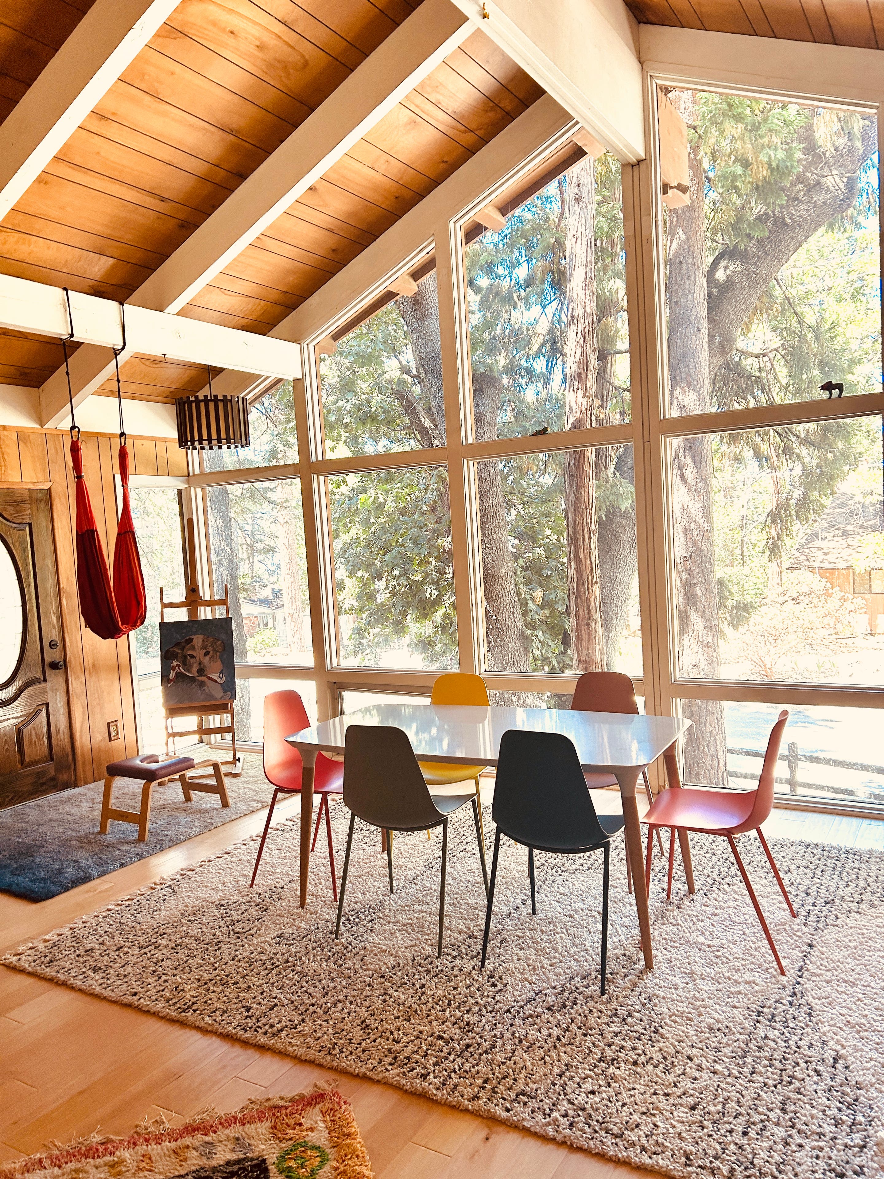Great room with amazing windows and trees on the outside.