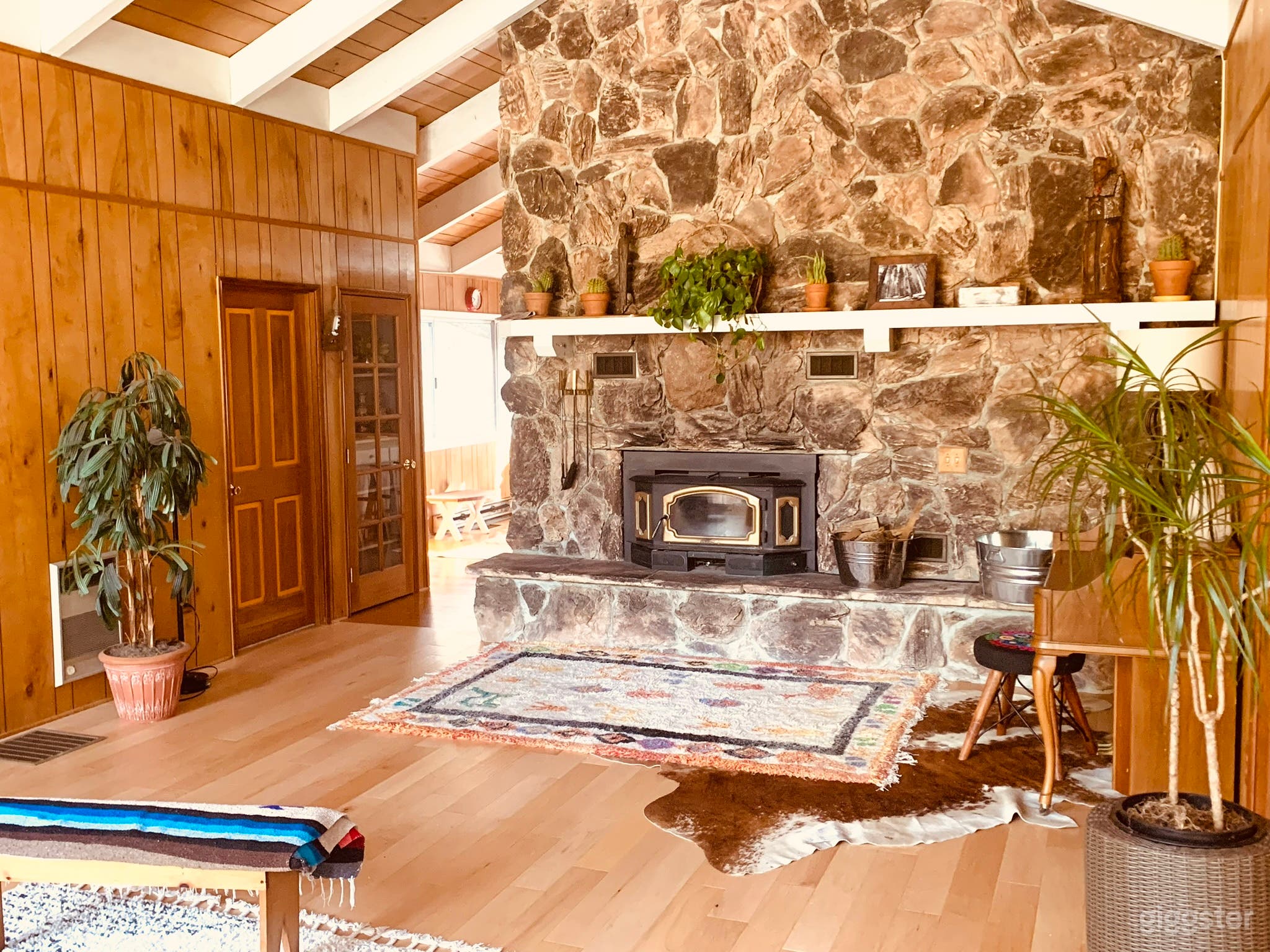 Stone fireplace and wood paneled walls in the living room.
