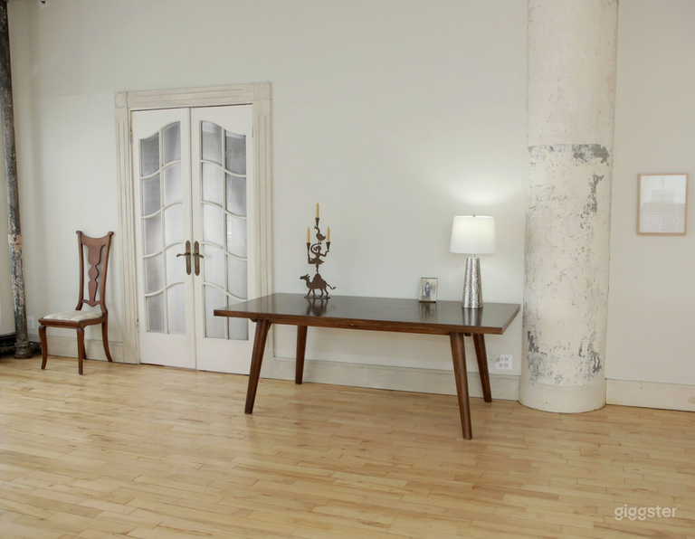  Large table in front of lighted French Doors. 