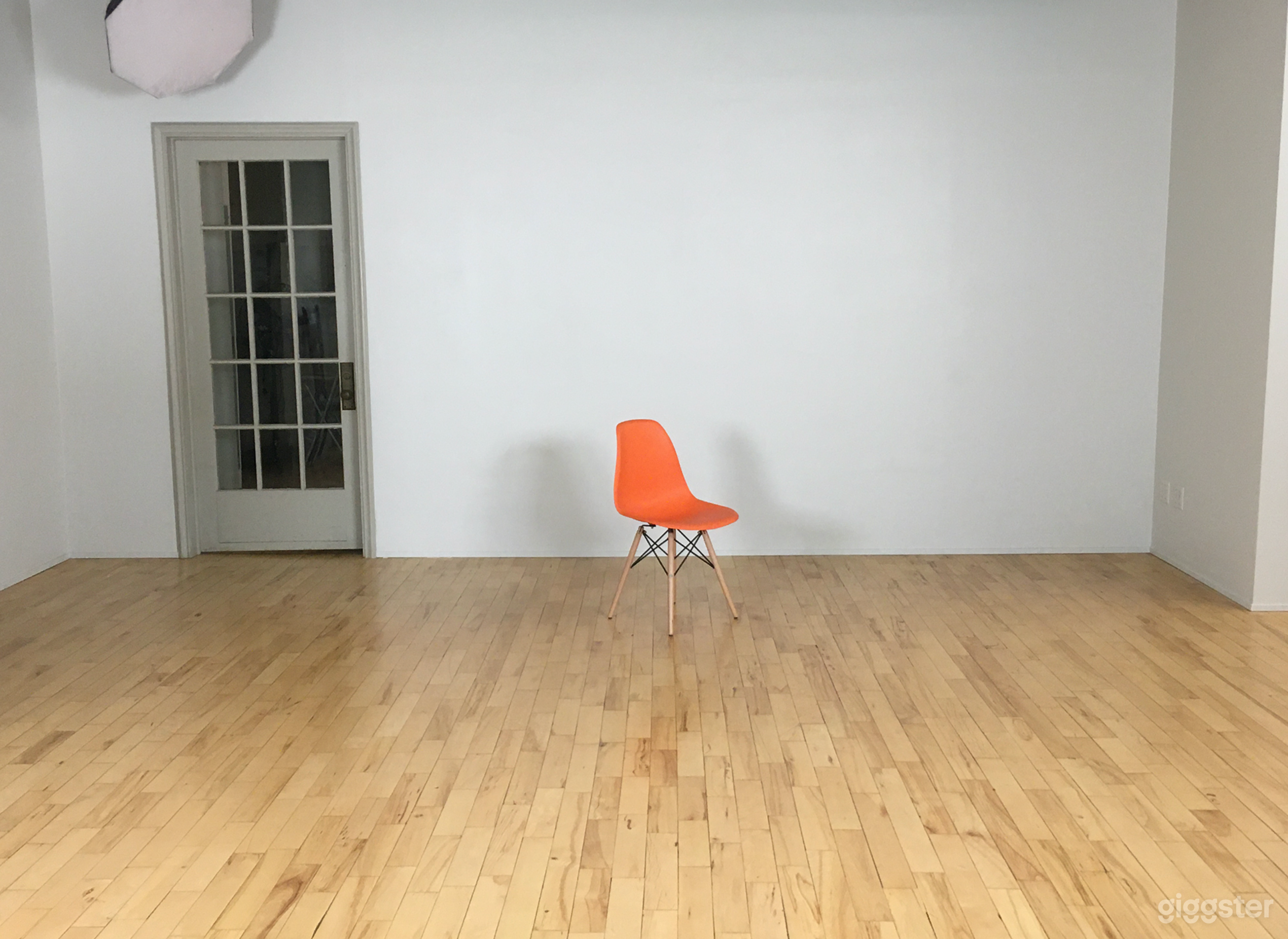 Large blank wall with working glass-paneled door. 10 feet high.