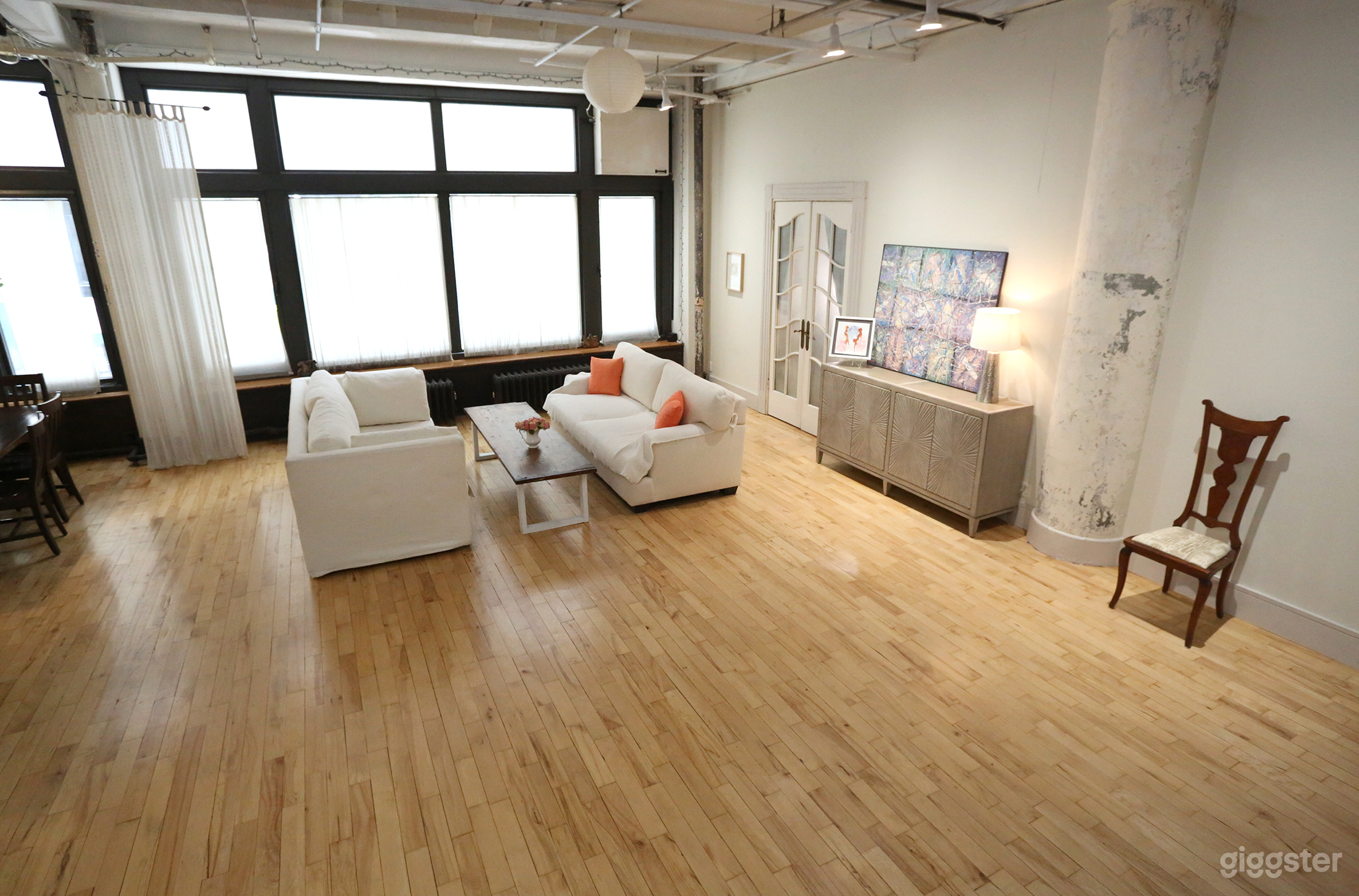 Two moveable couches and coffee table in front of natural daylight windows.
